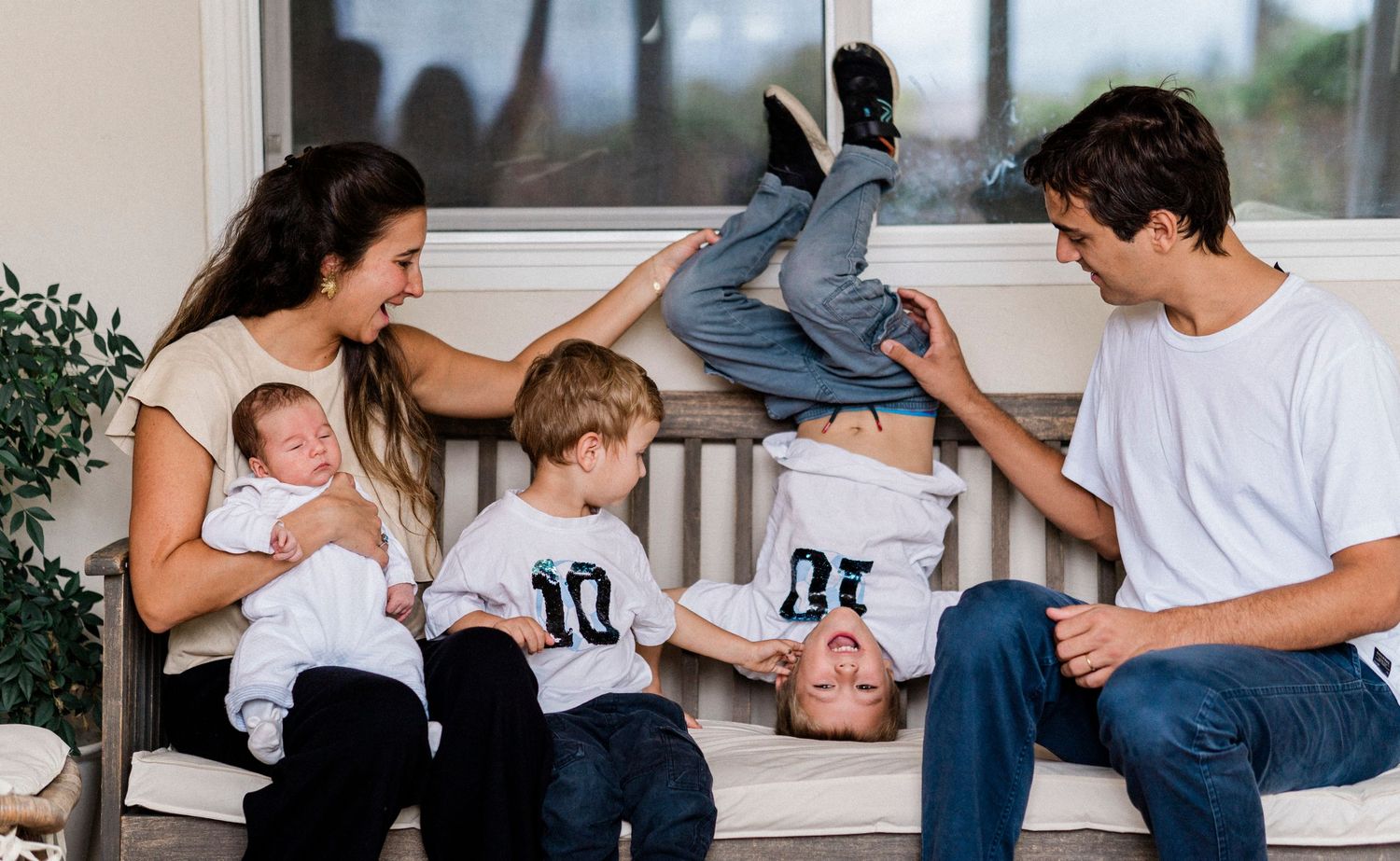 A collage of tender family moments shows parents and children bonding together on a white couch in casual attire.
