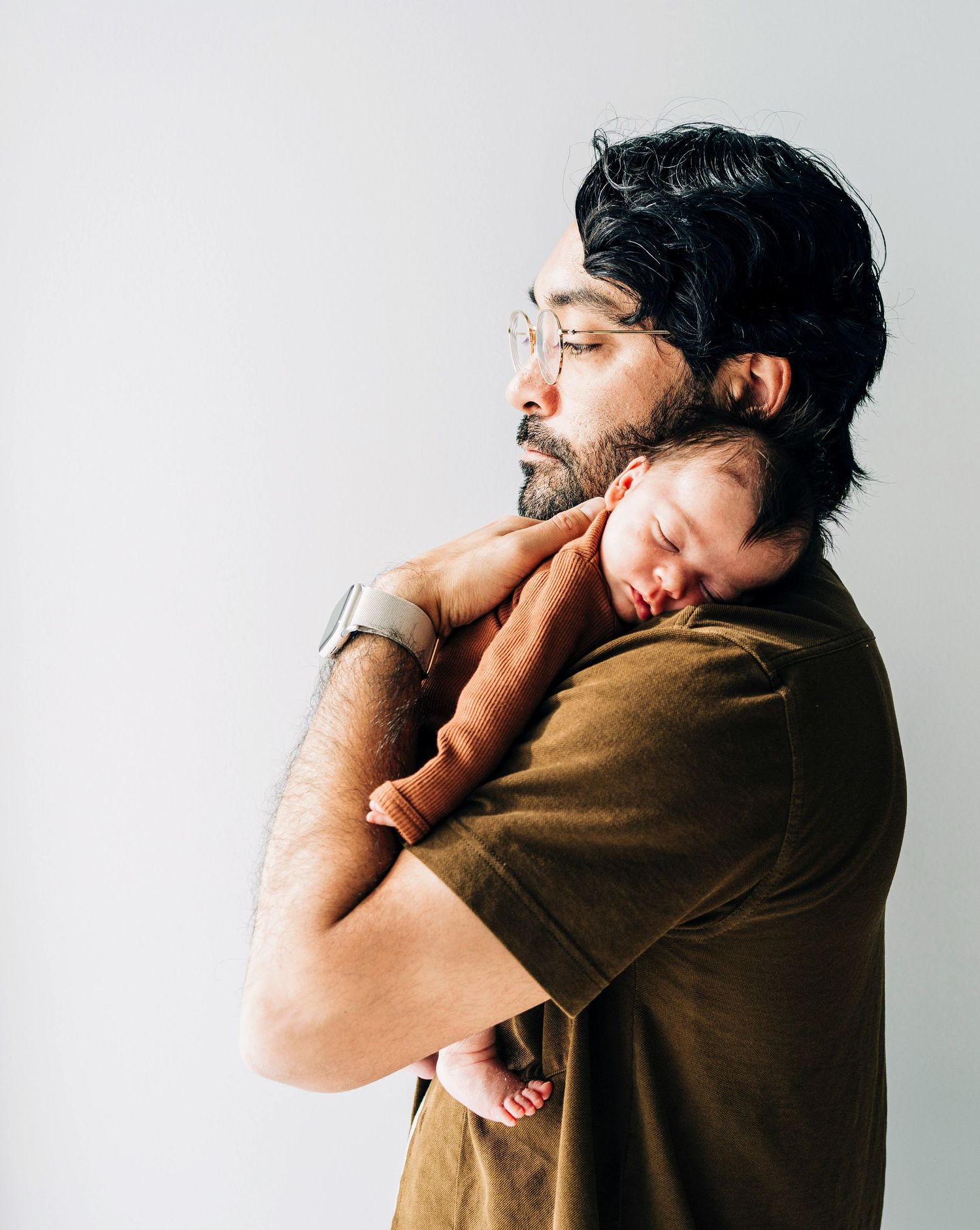 Emotional bonding sequence showing gentle care and affection against a white backdrop.