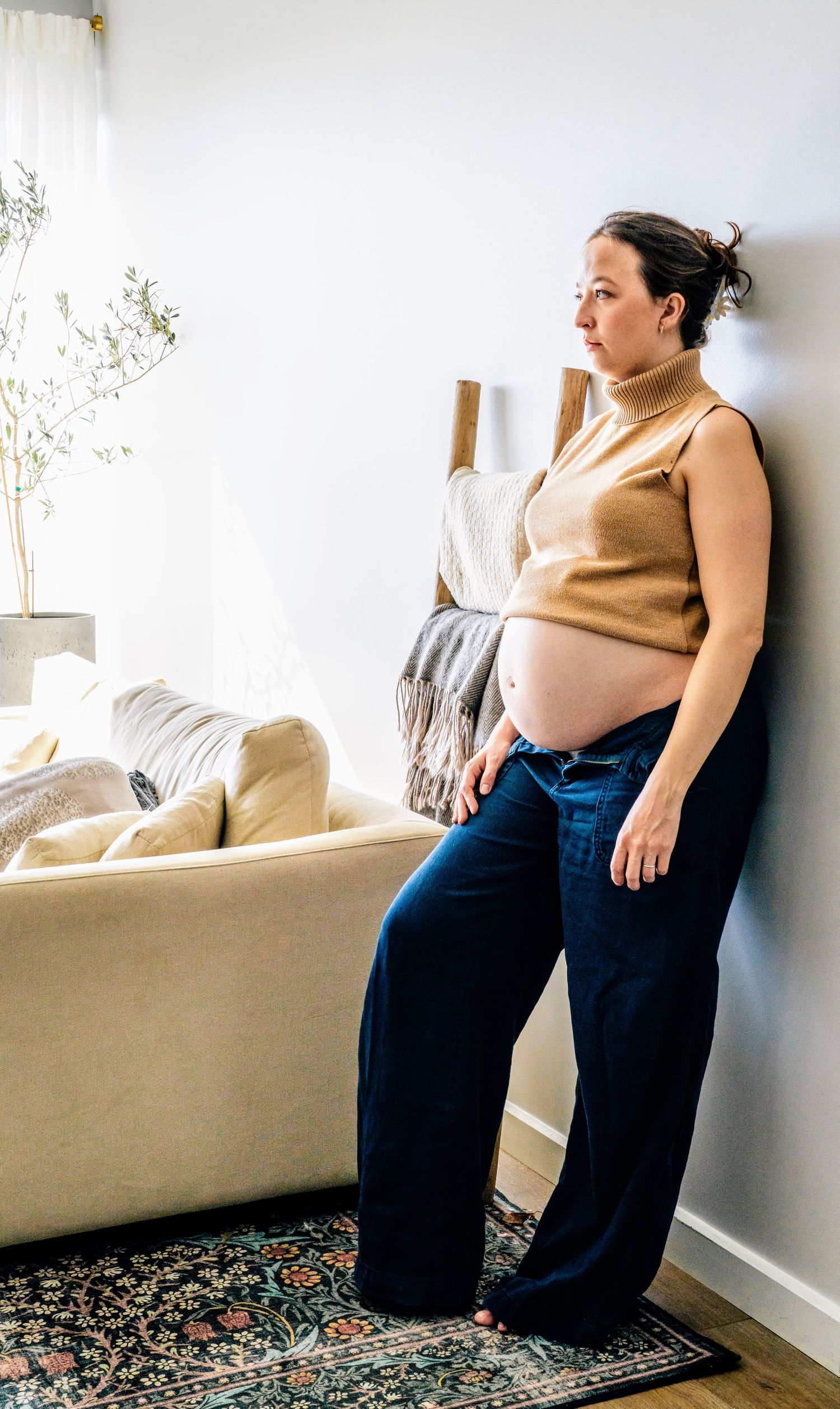 Candid maternity photos showing modern light and poses in a home.