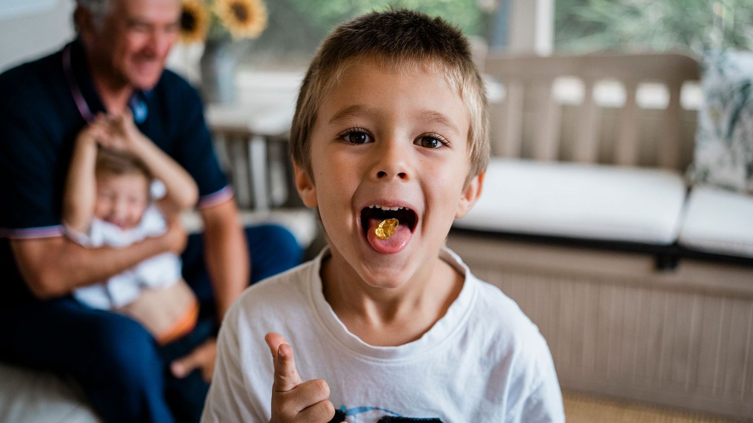 A collage of candid moments showing children making silly faces and expressions during a casual photo session.