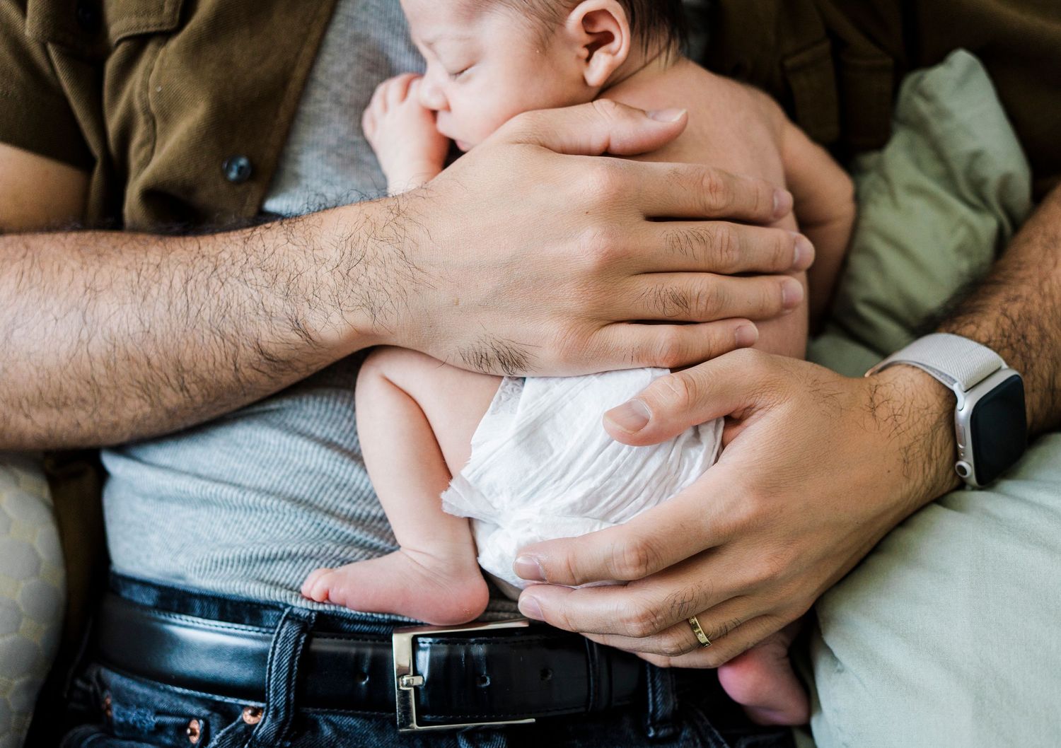 Close-up photos of gentle hand touches and embraces in natural lighting.