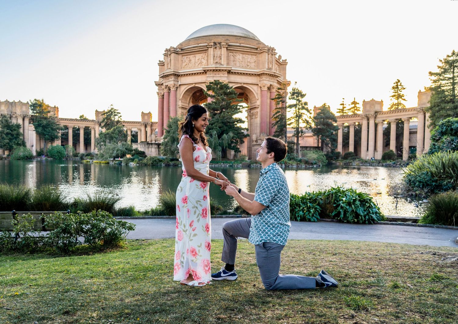 A proposal scene at the Palace of Fine Arts with its iconic dome and lagoon in the background.