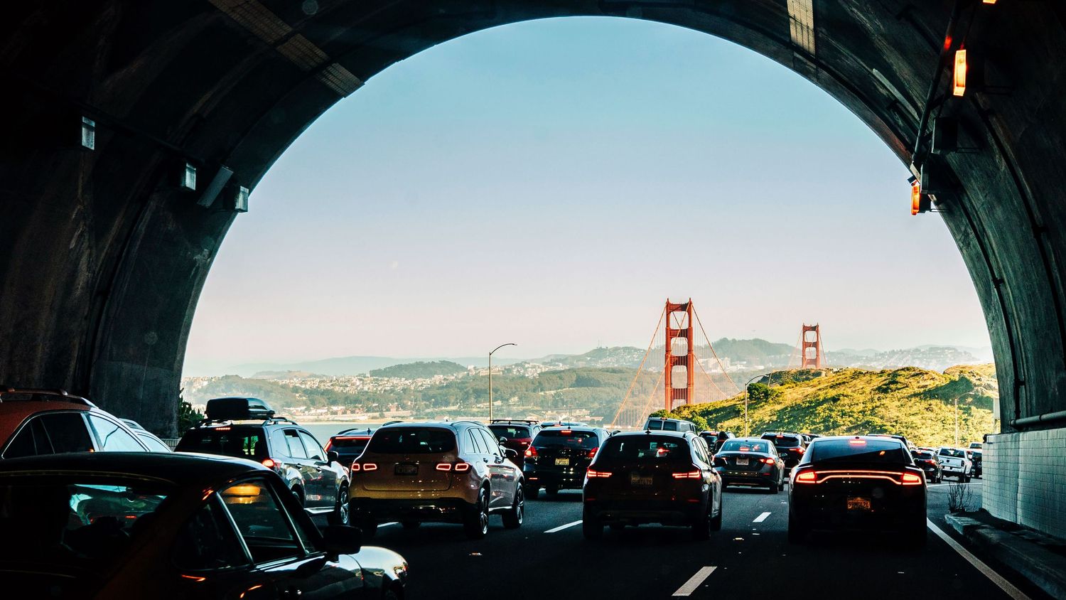 Panoramic view of the iconic Golden Gate Bridge stretching across San Francisco Bay at sunset.