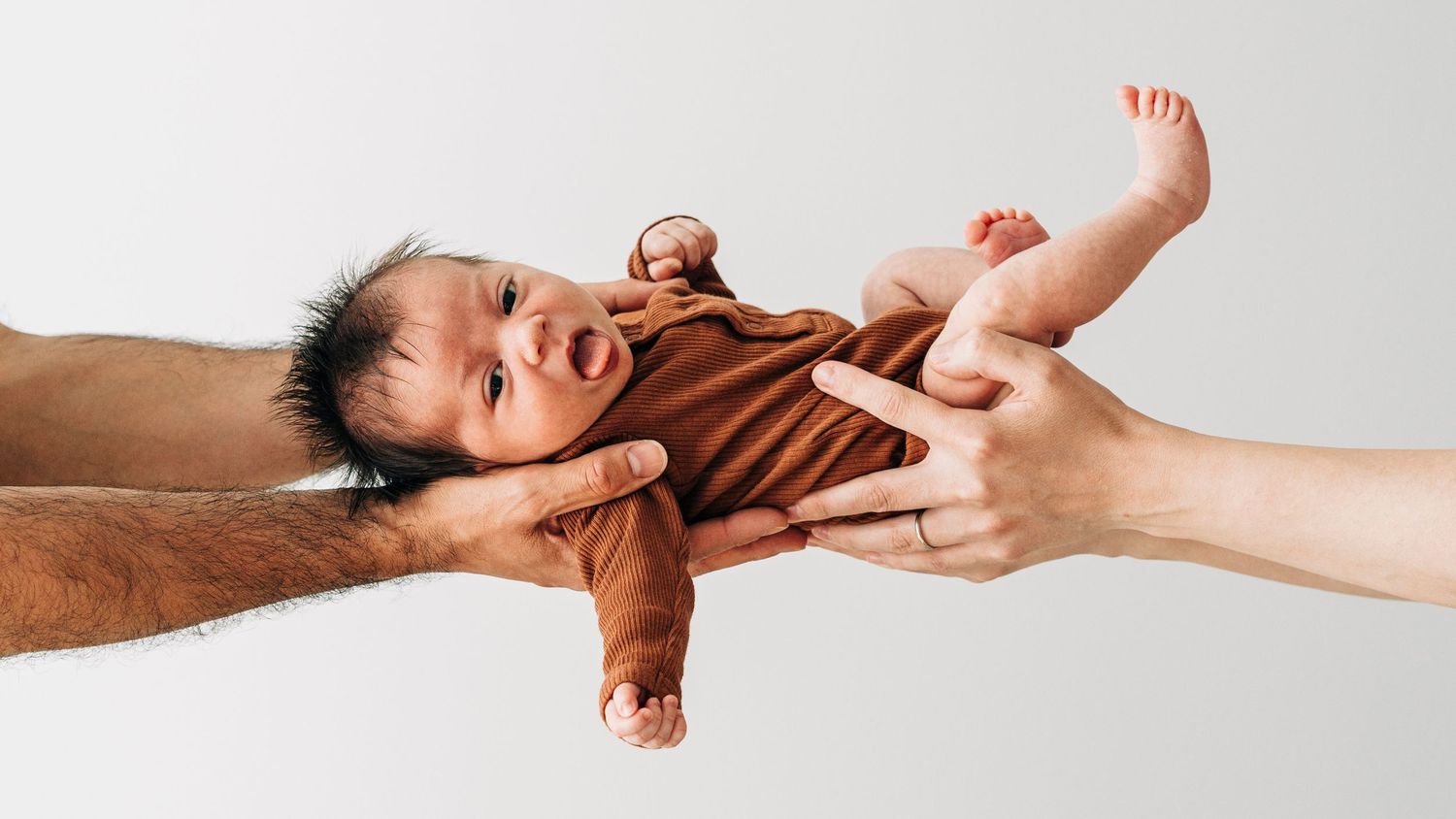 A dramatic sequence of hands reaching and grasping each other against a white background.