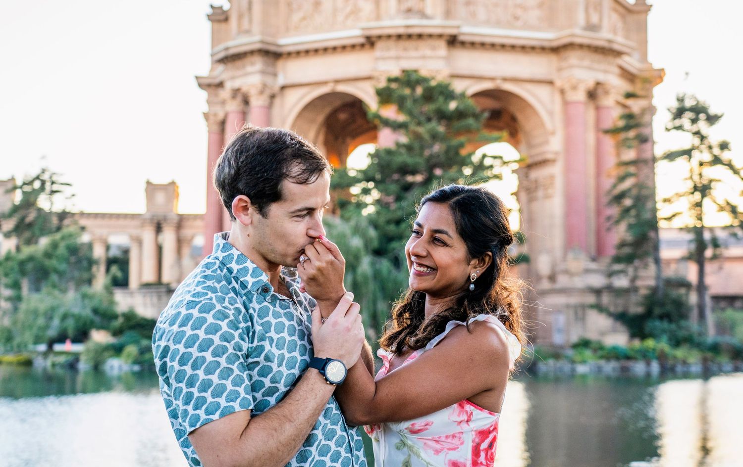 A romantic moment captured at the Palace of Fine Arts with classical architecture in background.