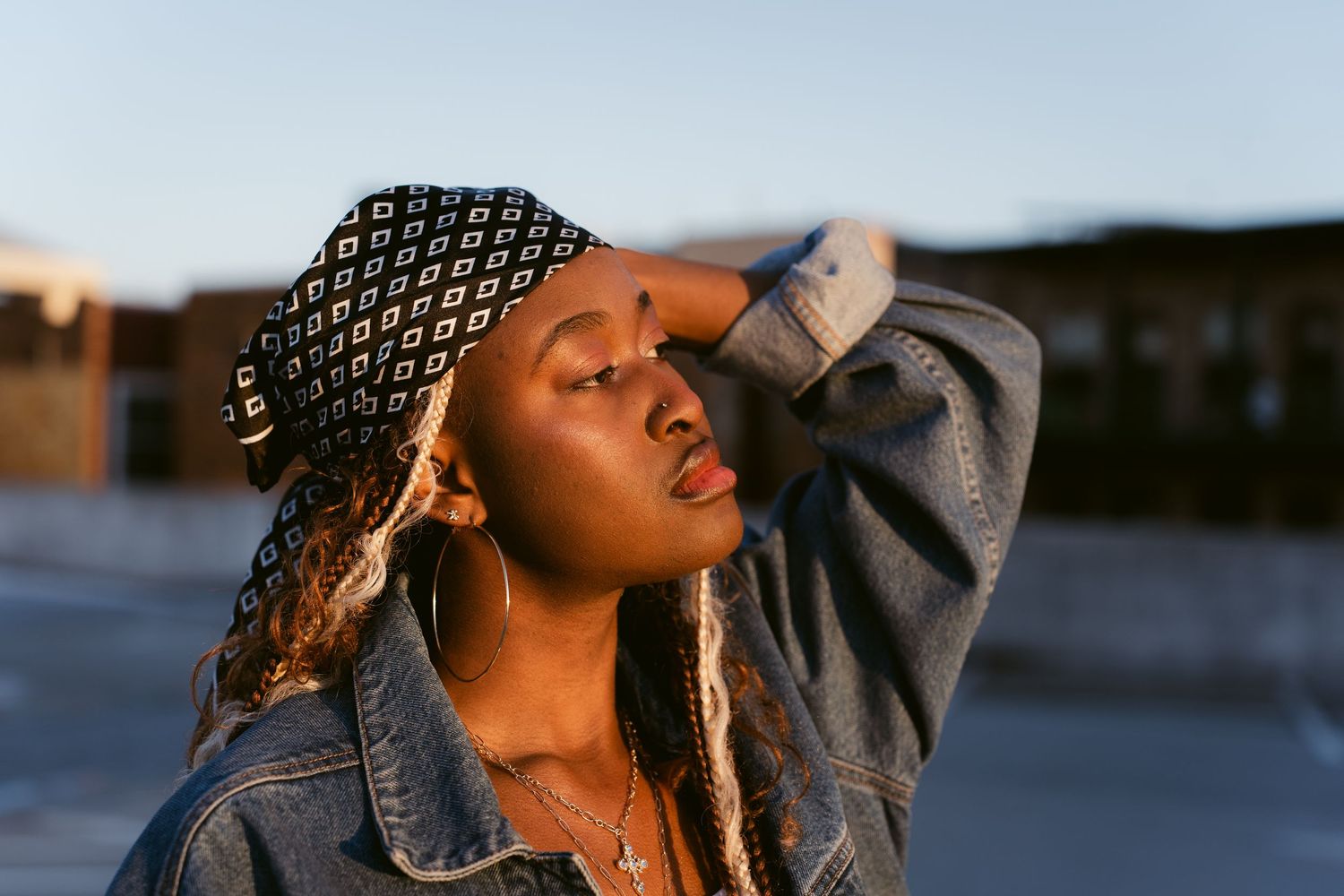Portrait image of a woman seriously looking into the distance with the sun hitting her face