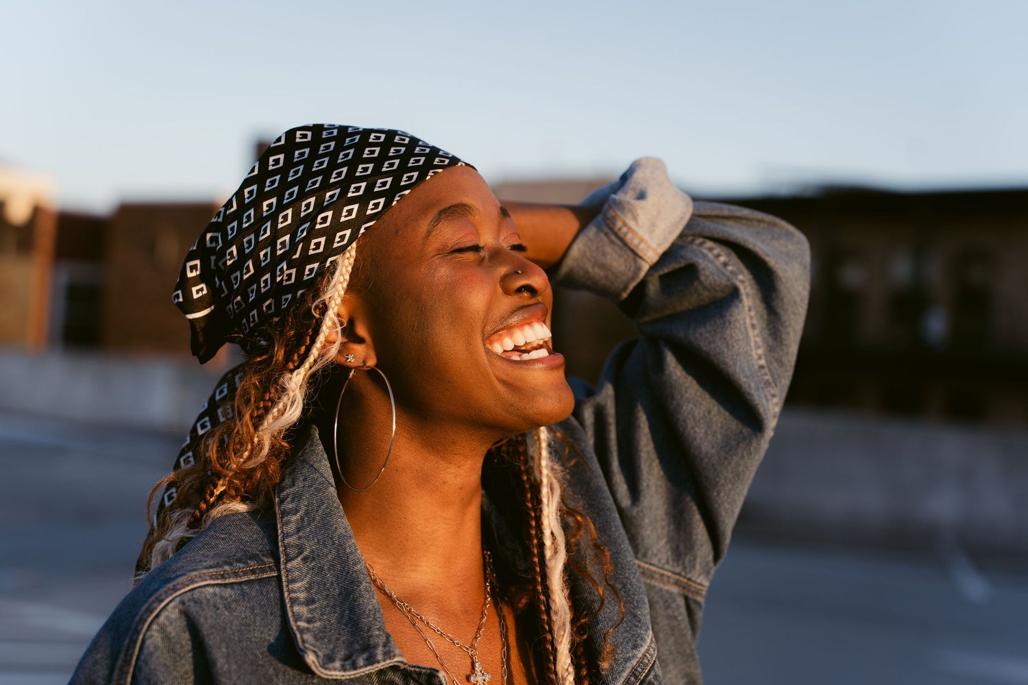 Portrait image of a woman laughing with the sun hitting her face