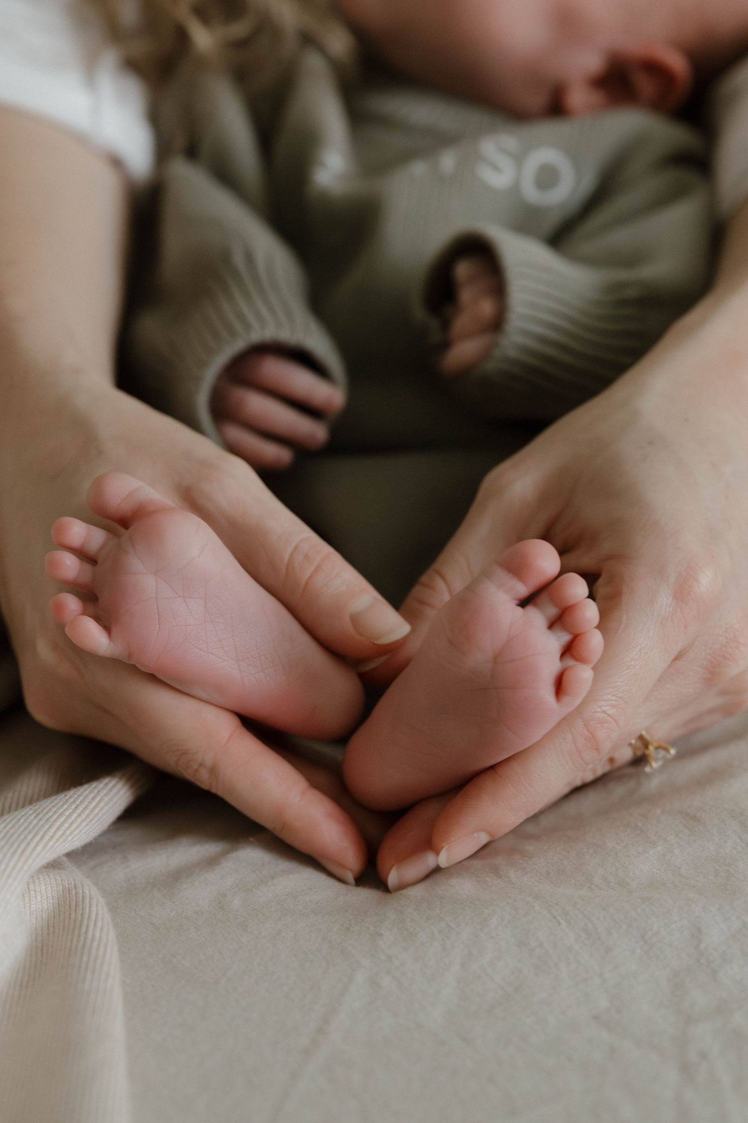Close-up series of hands gently touching and intertwining on soft white bedding in natural light.