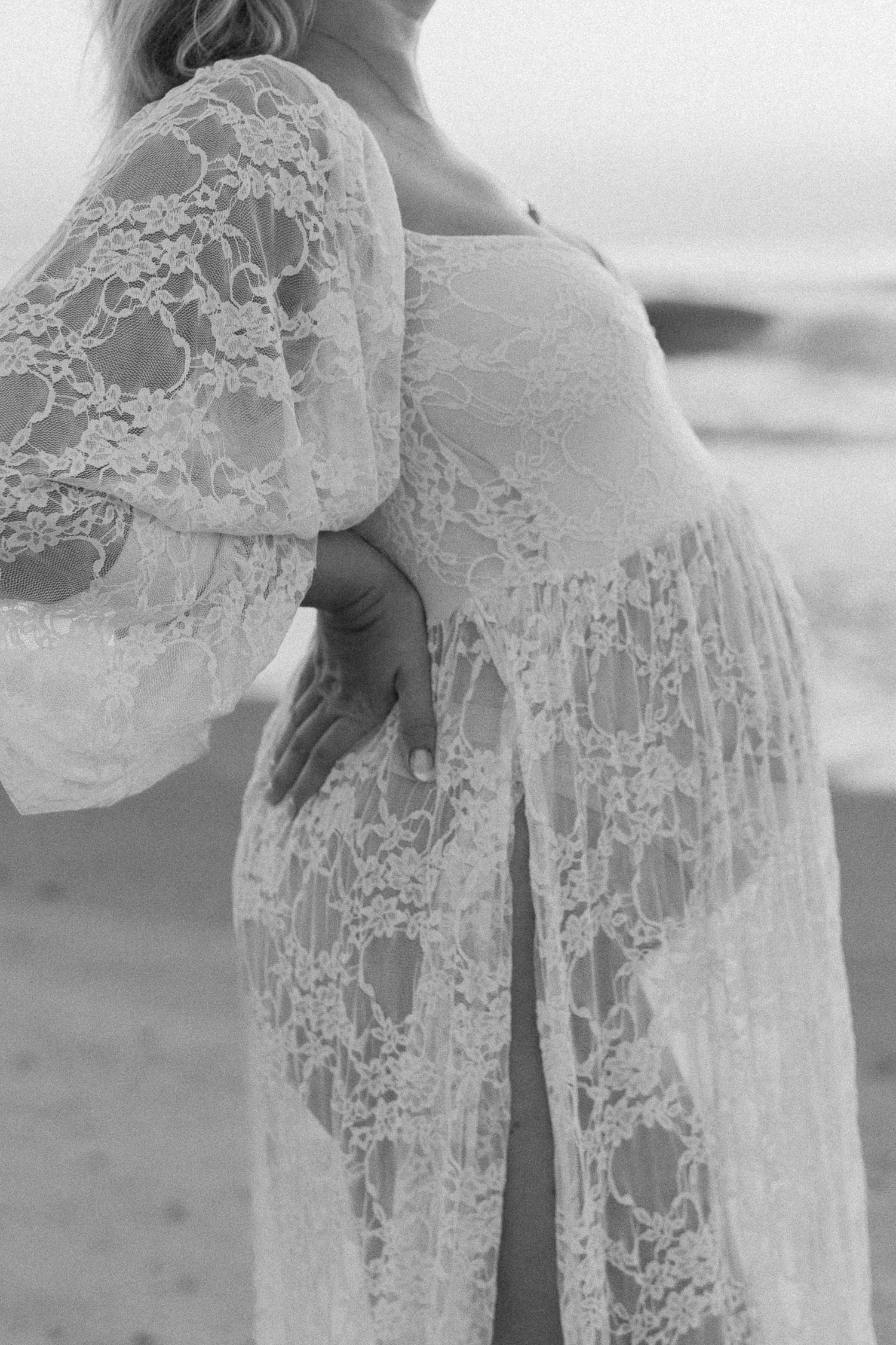 Close-up details of delicate white lace fabric with intricate patterns flowing in the breeze.