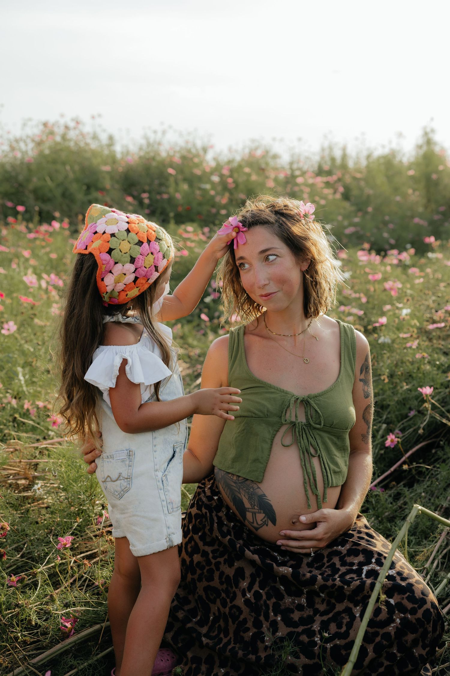 A tender moment between family members in a blooming summer wildflower field.