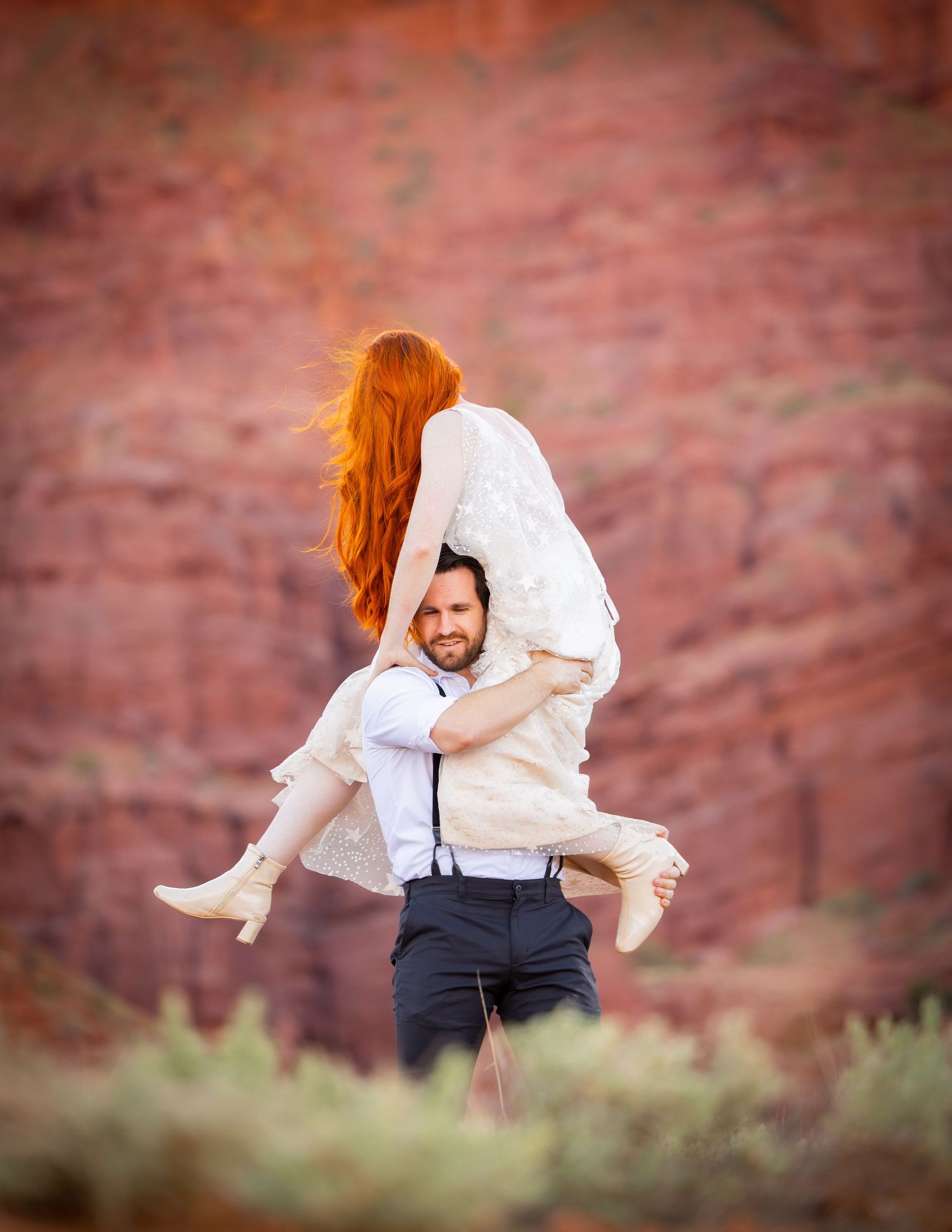 Intimate wedding moments photographed against dramatic red rock canyon walls.