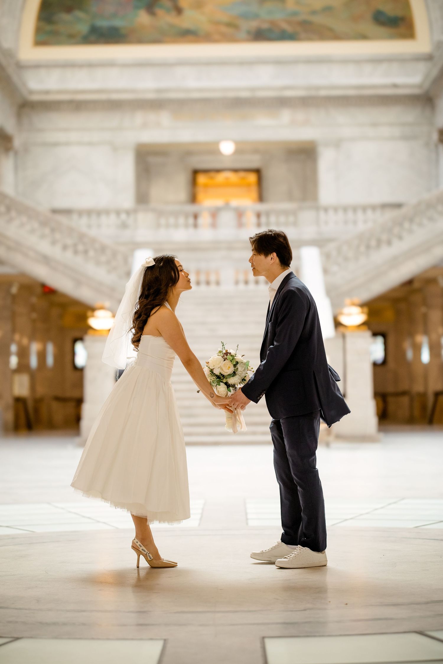 Creative miniature wedding photo sequence captured in an ornate white marble interior.