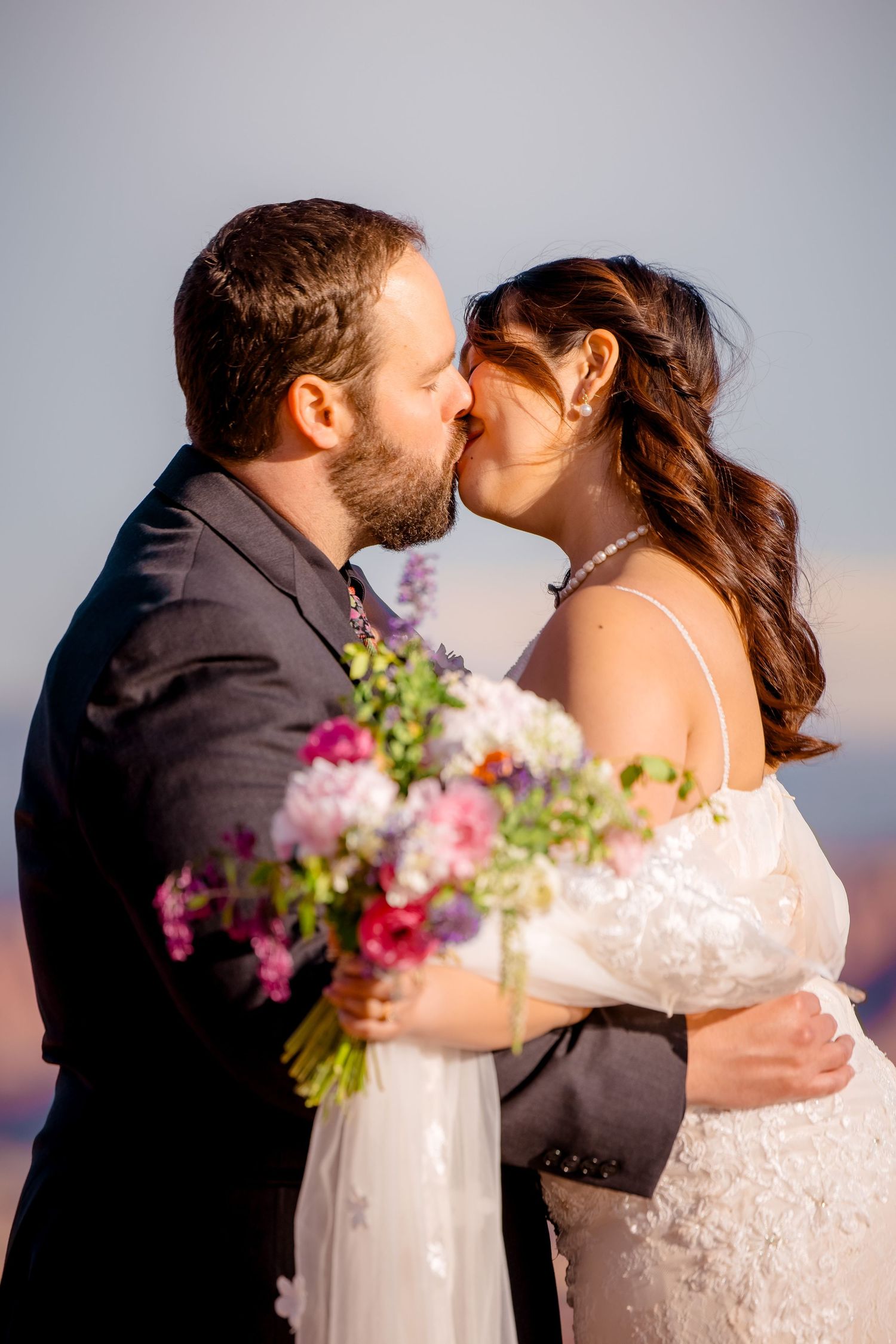 A series of romantic sunset wedding photos with pink floral bouquet accents.