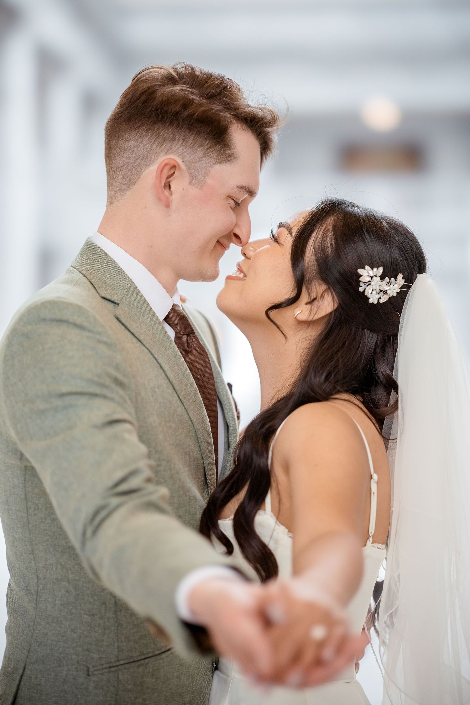 A romantic wedding kiss sequence captured in soft focus with the couple in elegant attire.