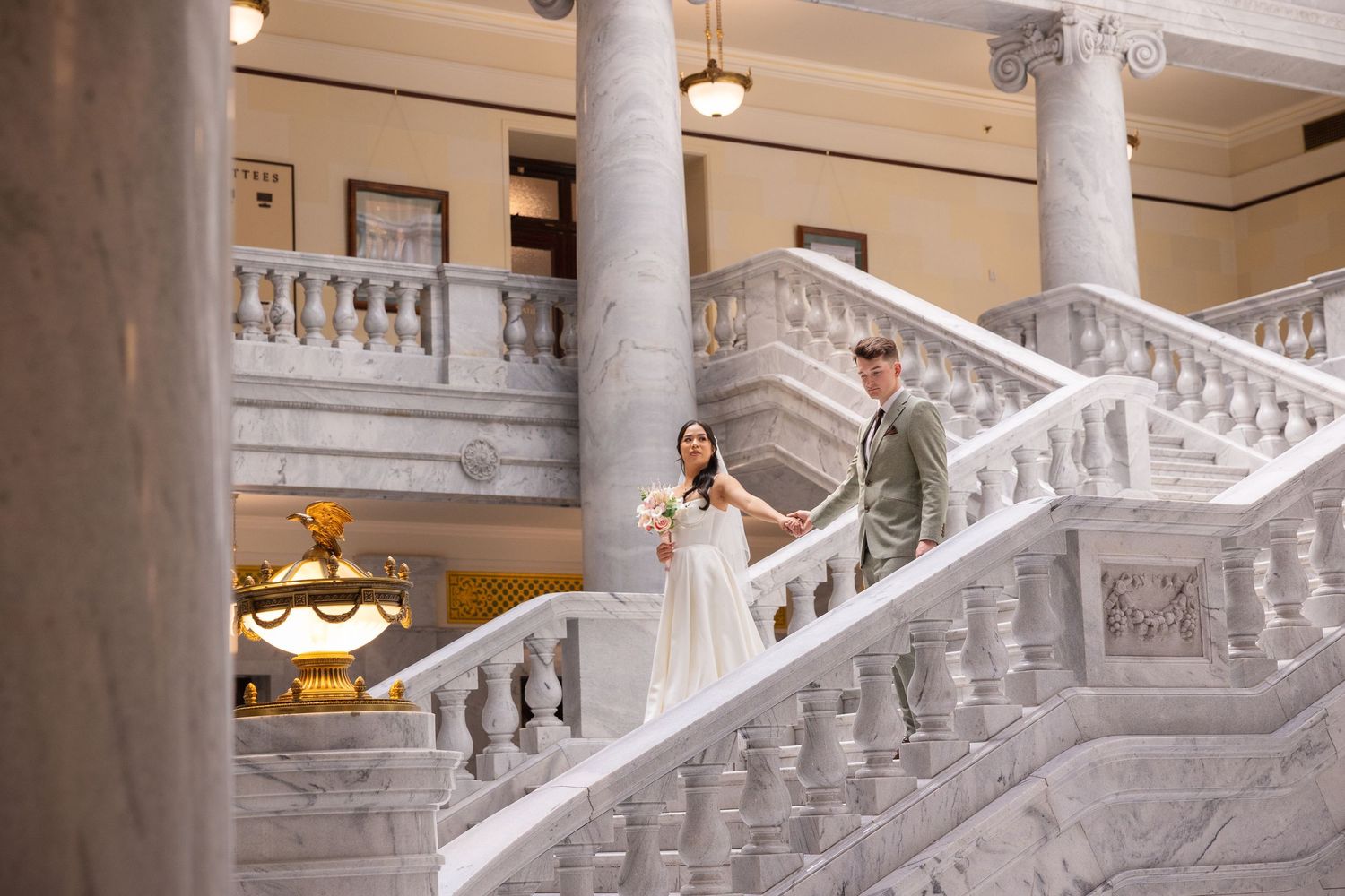 Architectural details of ornate white marble staircase in classical building.