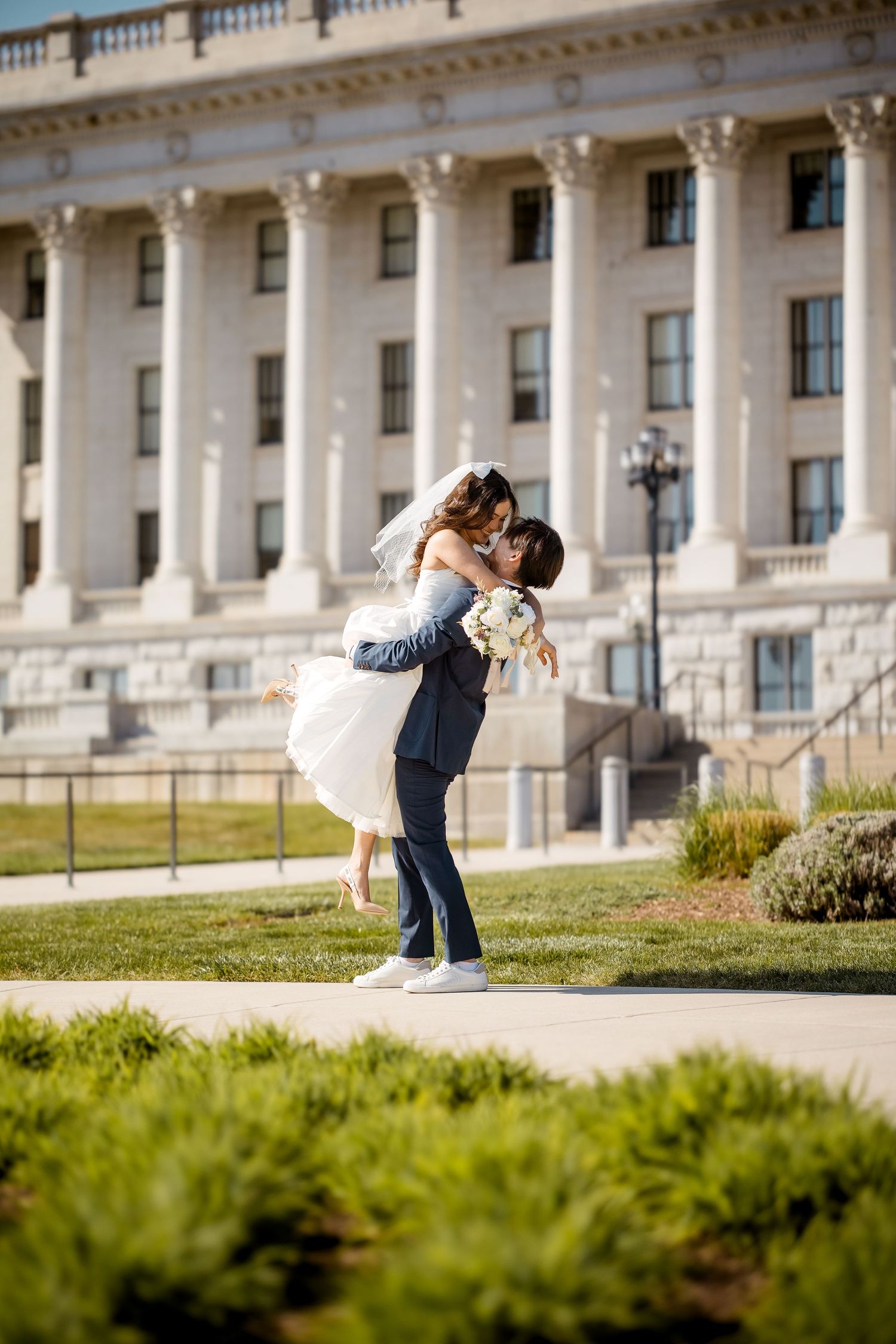 Romantic wedding sequence photographed outside a grand classical building with columns.