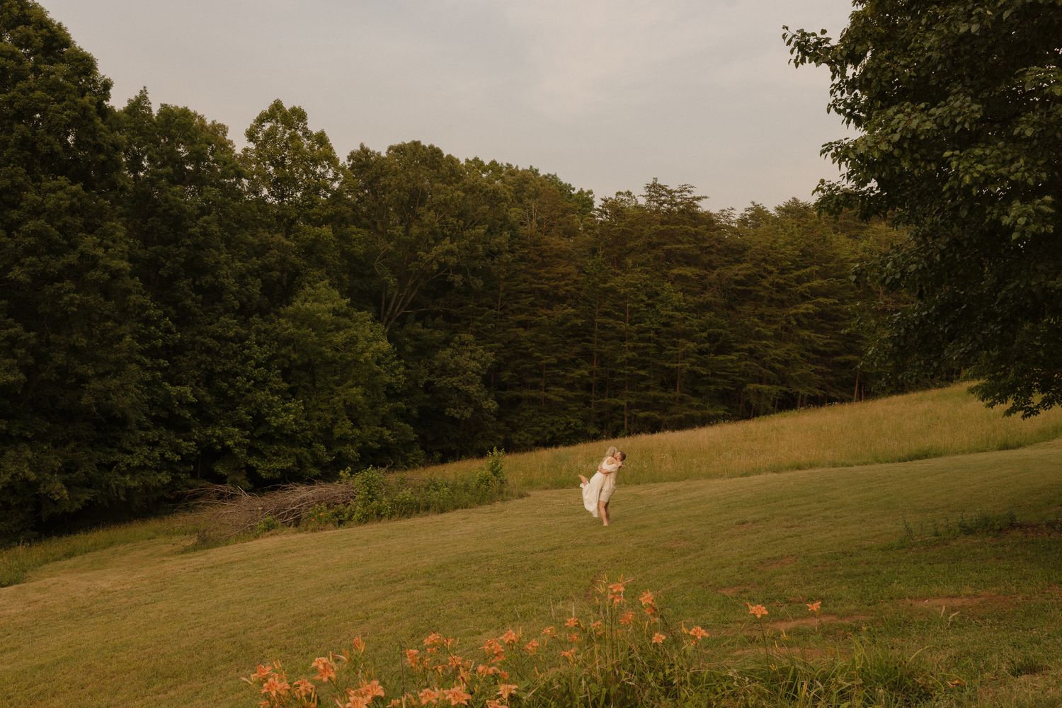 A dreamy meadow landscape with wildflowers and a lone figure in white.