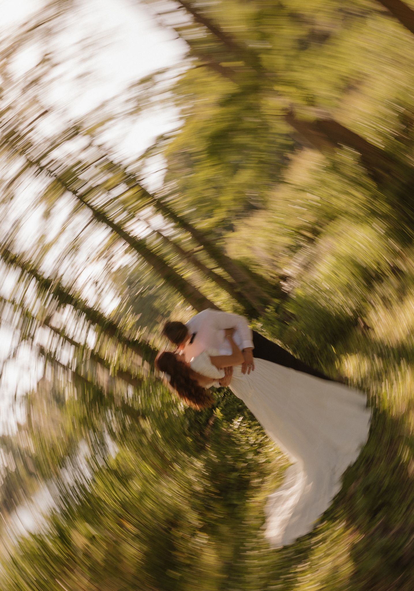 A creative spiral effect wedding photo taken from above showing a couple in nature.