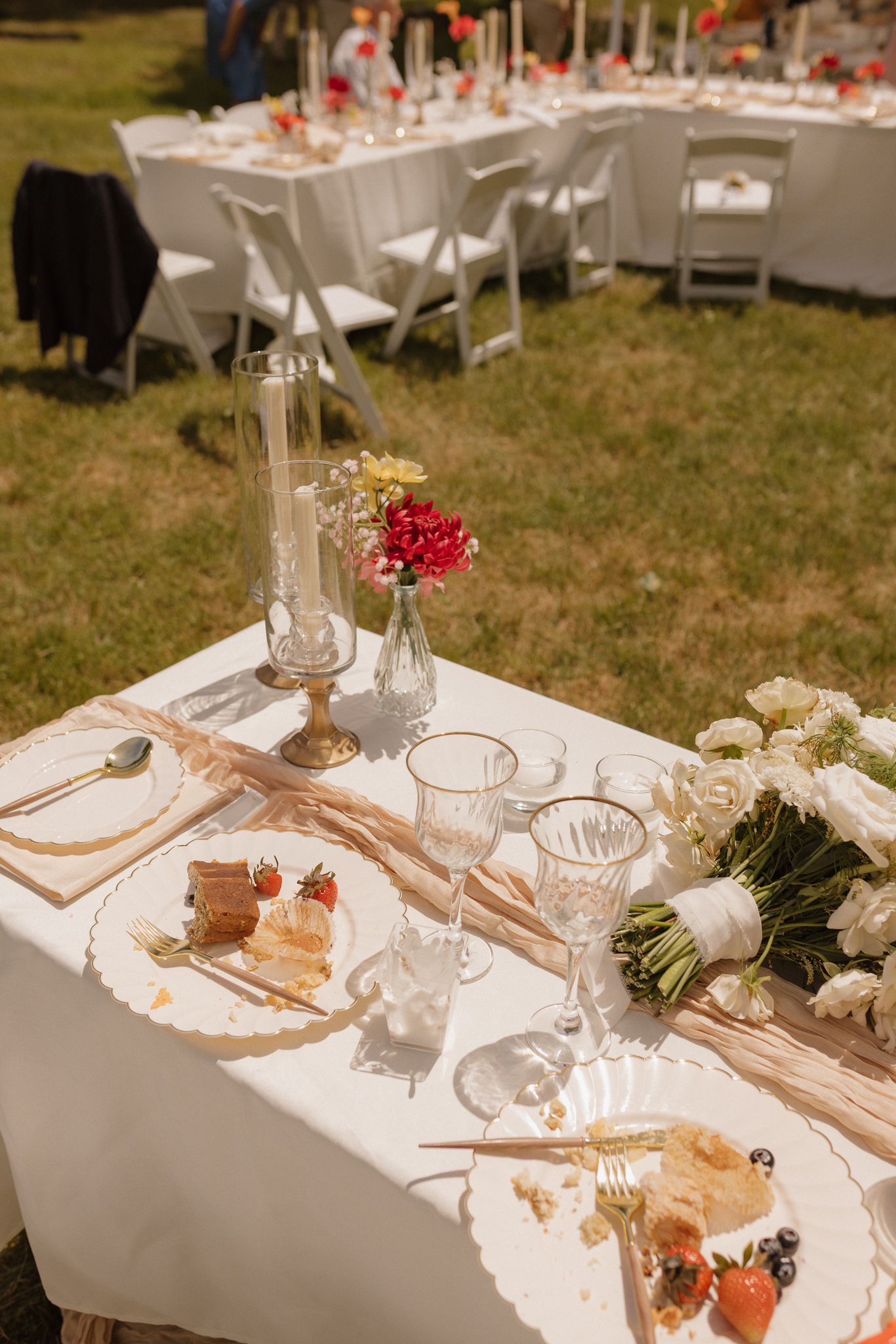 Elegant wedding reception table settings with white linens and floral centerpieces.
