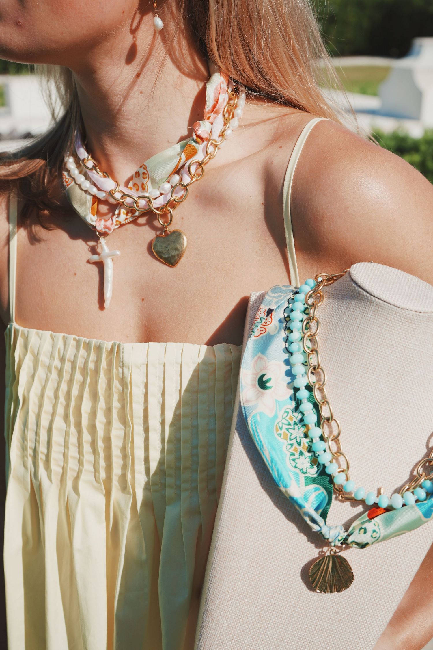 Collection of artisan necklaces featuring turquoise stones and copper chains displayed on pale cream backgrounds.
