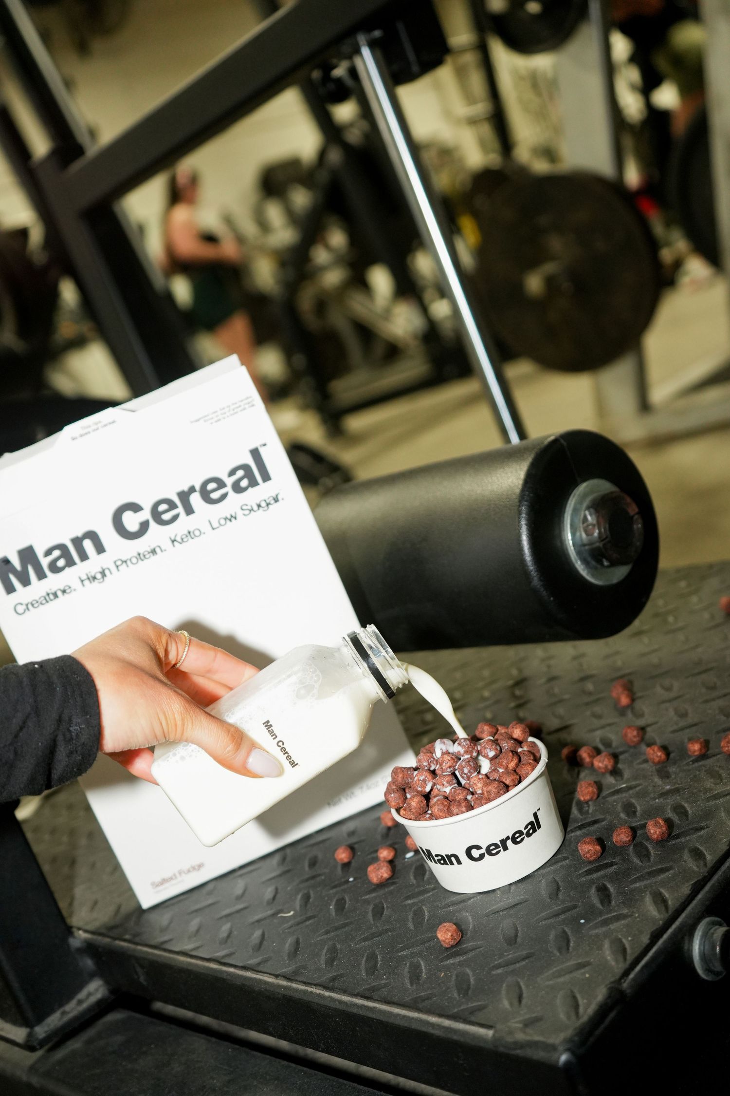 Sequence showing cereal being poured into a bowl on a black textured surface with scattered red berries.