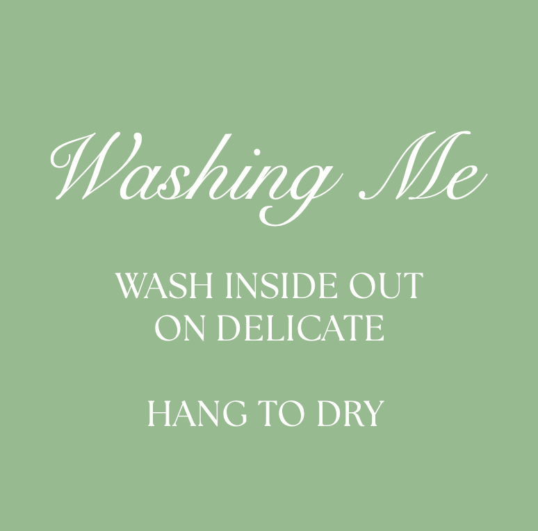 Three sage green washing instruction labels for laundry care showing text about gentle washing and drying.