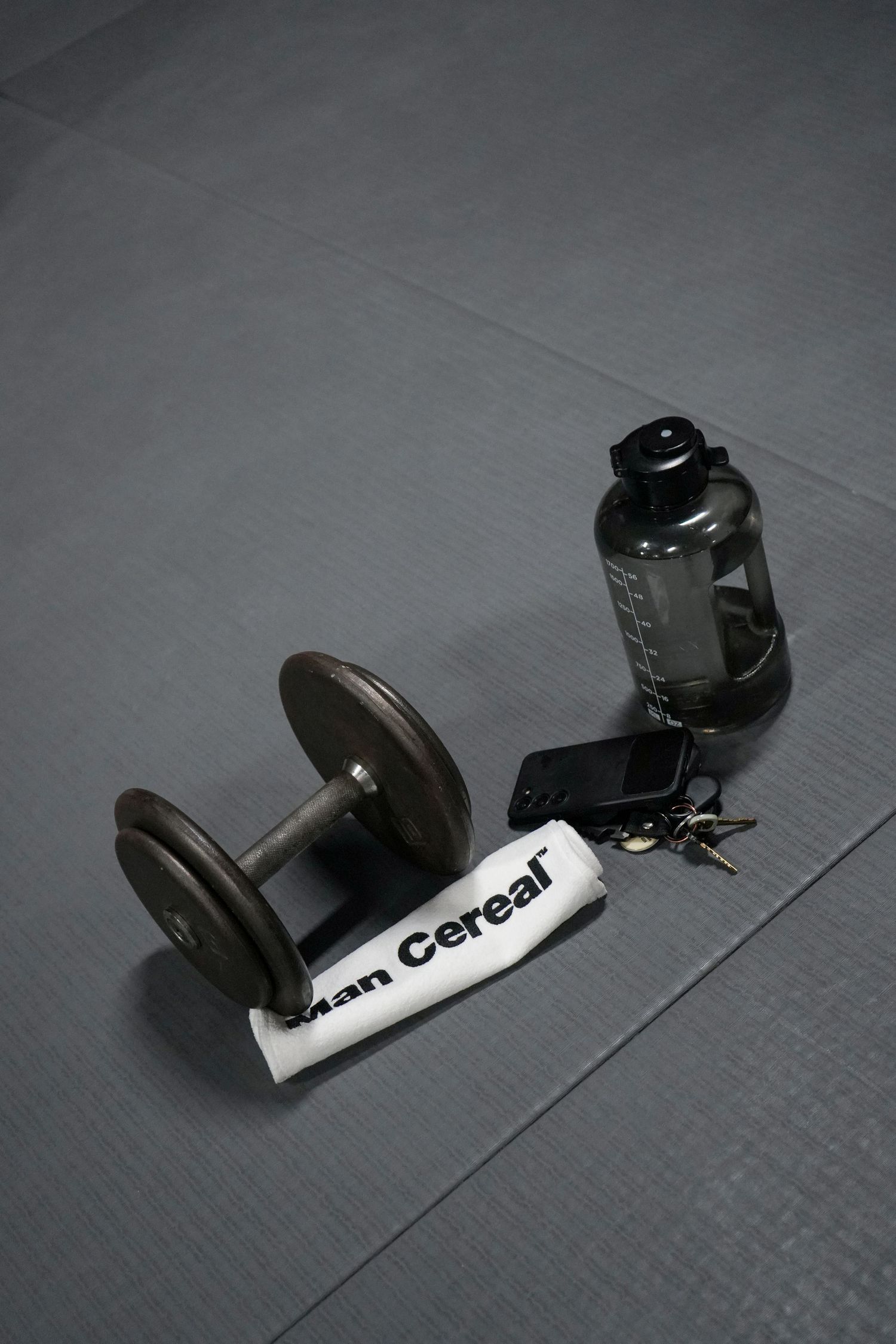 Black camera equipment or accessories arranged on a dark gray surface.