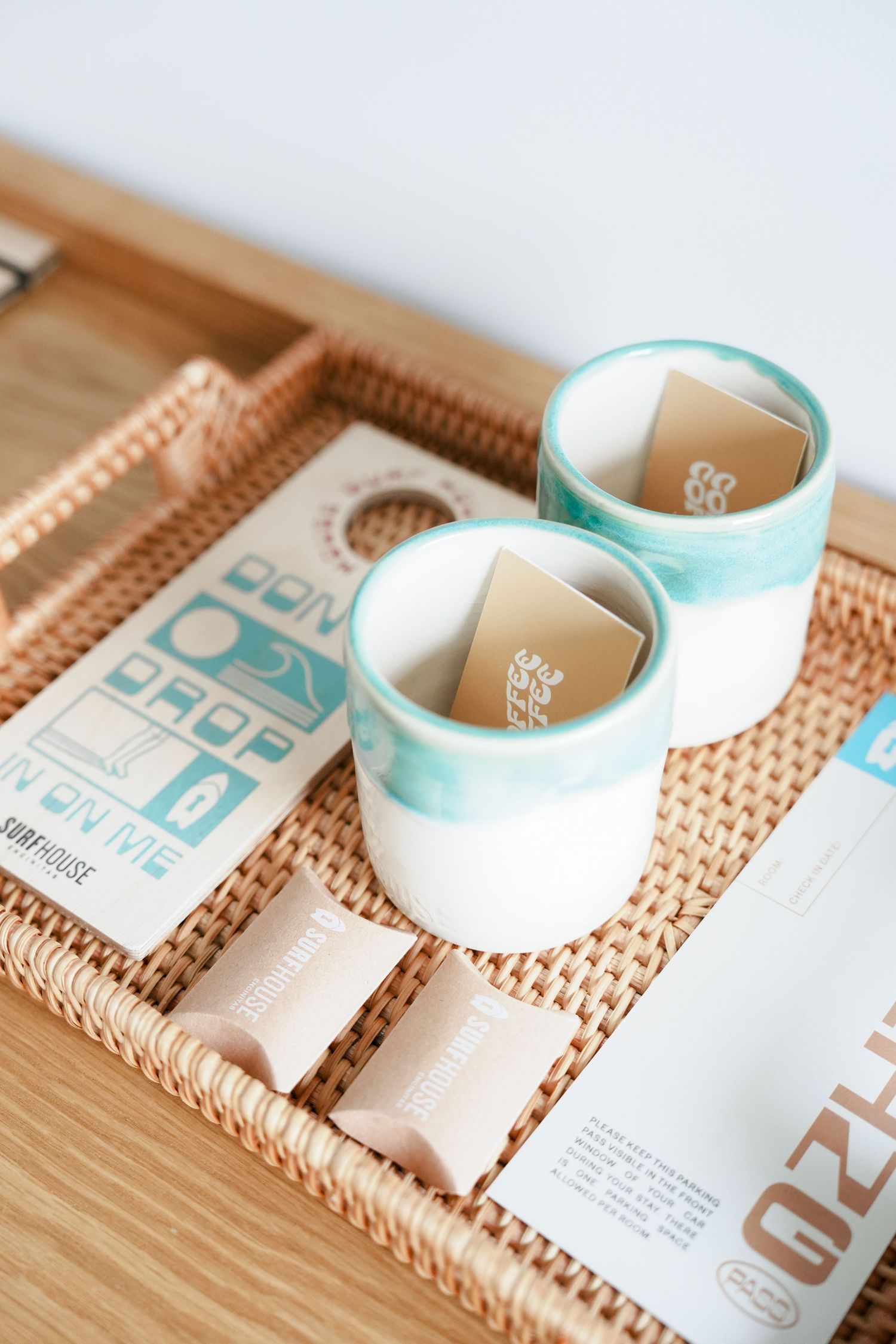 A roll of mint green and white medical tape arranged in a diagonal line on a woven bamboo surface.