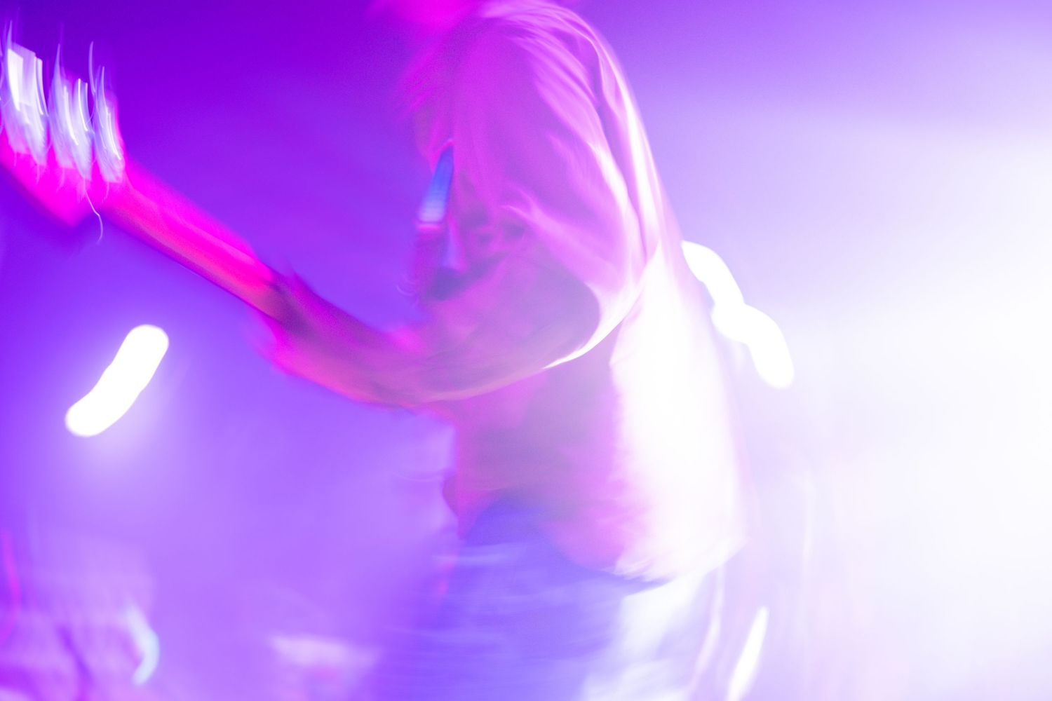 Vibrant pink and purple lights create an abstract blurred pattern with a dreamy atmospheric effect.