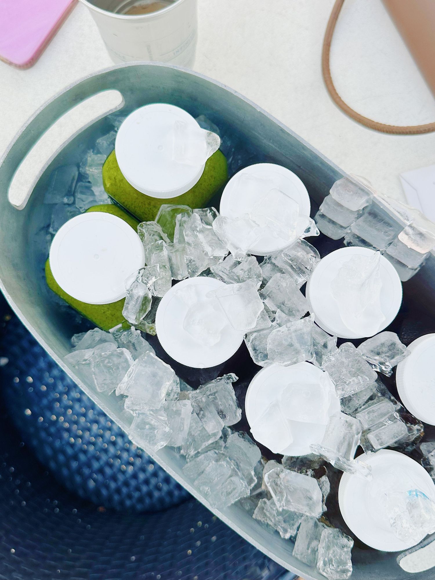 A row of ice cubes and lime wedges arranged in a curved blue tray for serving drinks at a party.