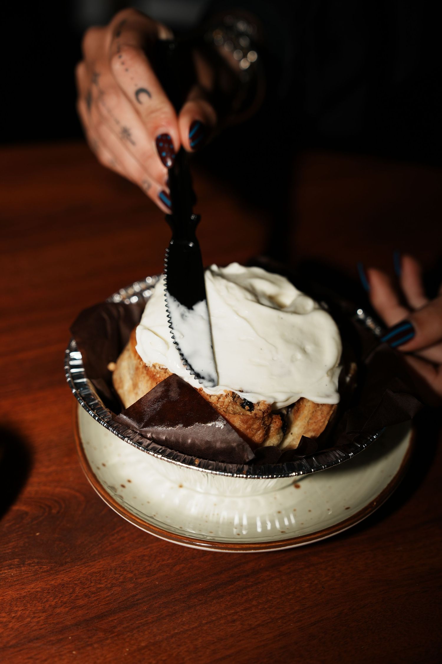 A series of photos showing chocolate pie being served onto white plates in dim lighting on a wooden table.