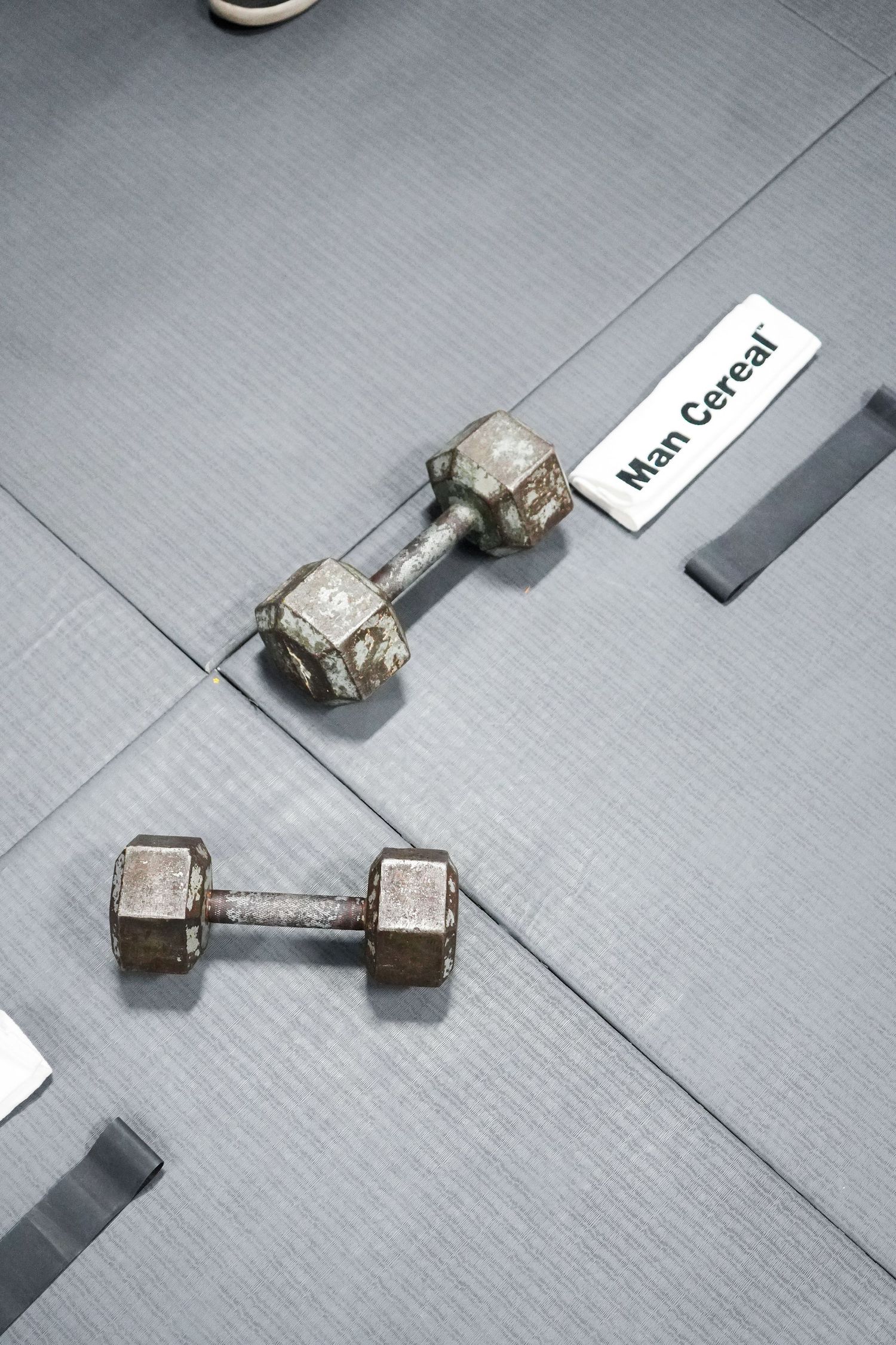A sequence of images showing a small metallic component being rotated and positioned at different angles on a gray surface.