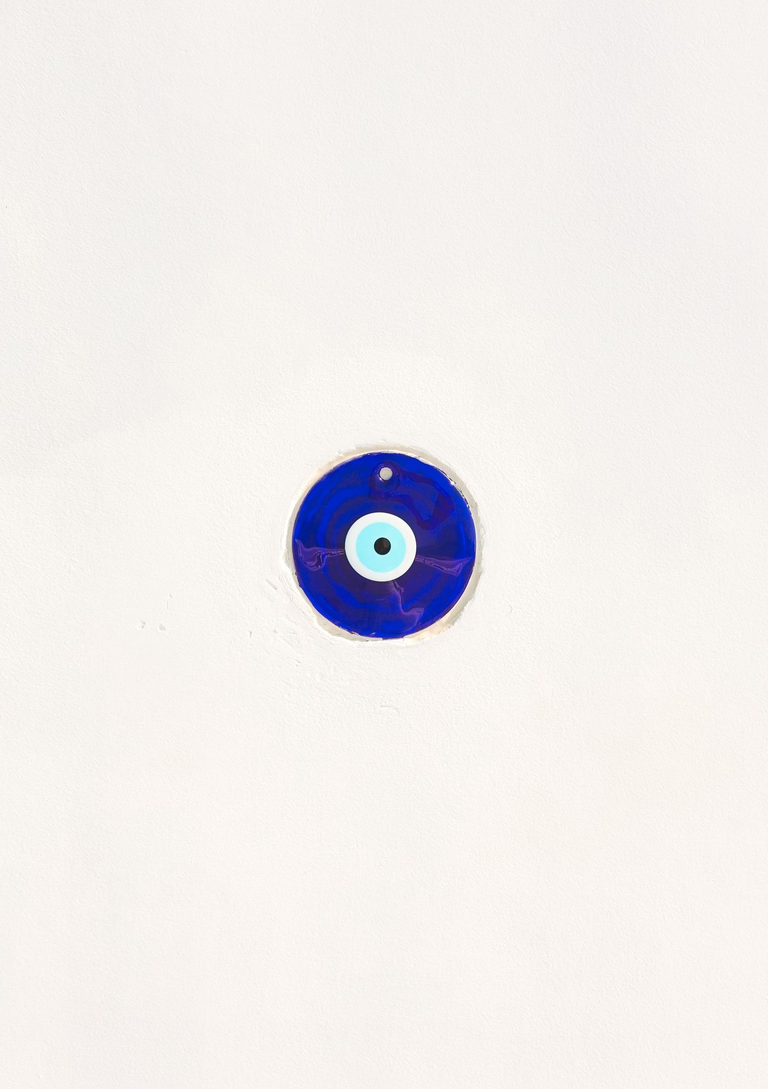 Traditional blue evil eye protection amulet isolated on white background.