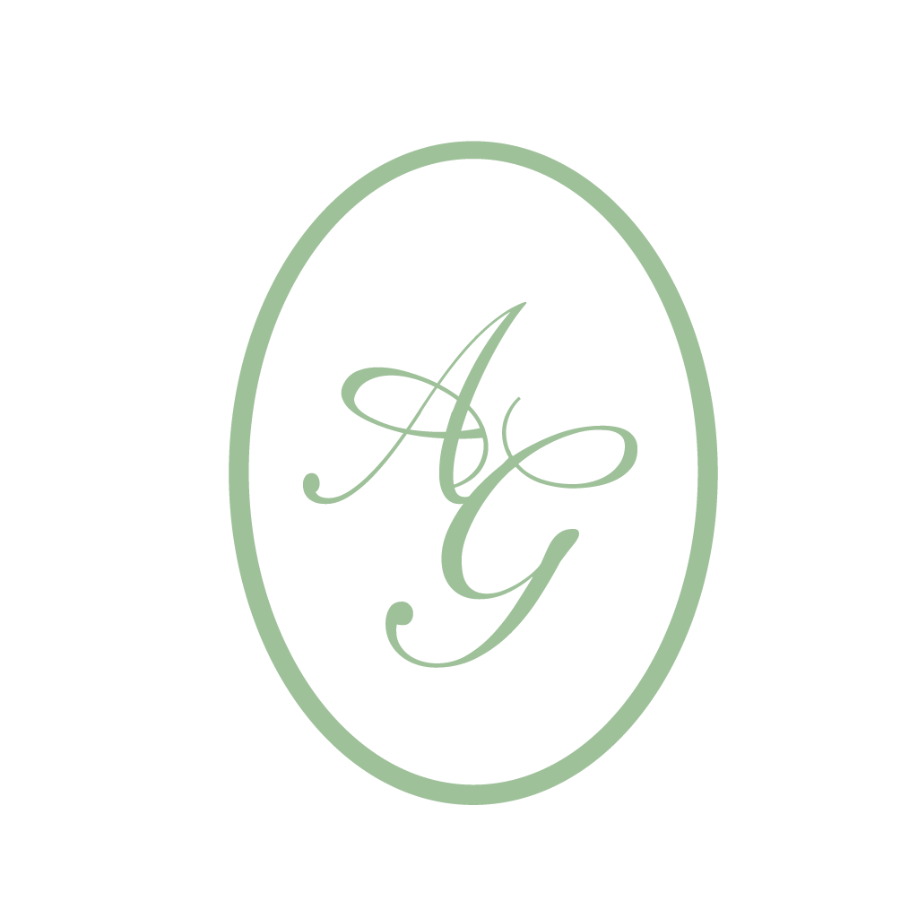 An elegant monogram logo design featuring the letters AG in sage green cursive script within an oval frame.