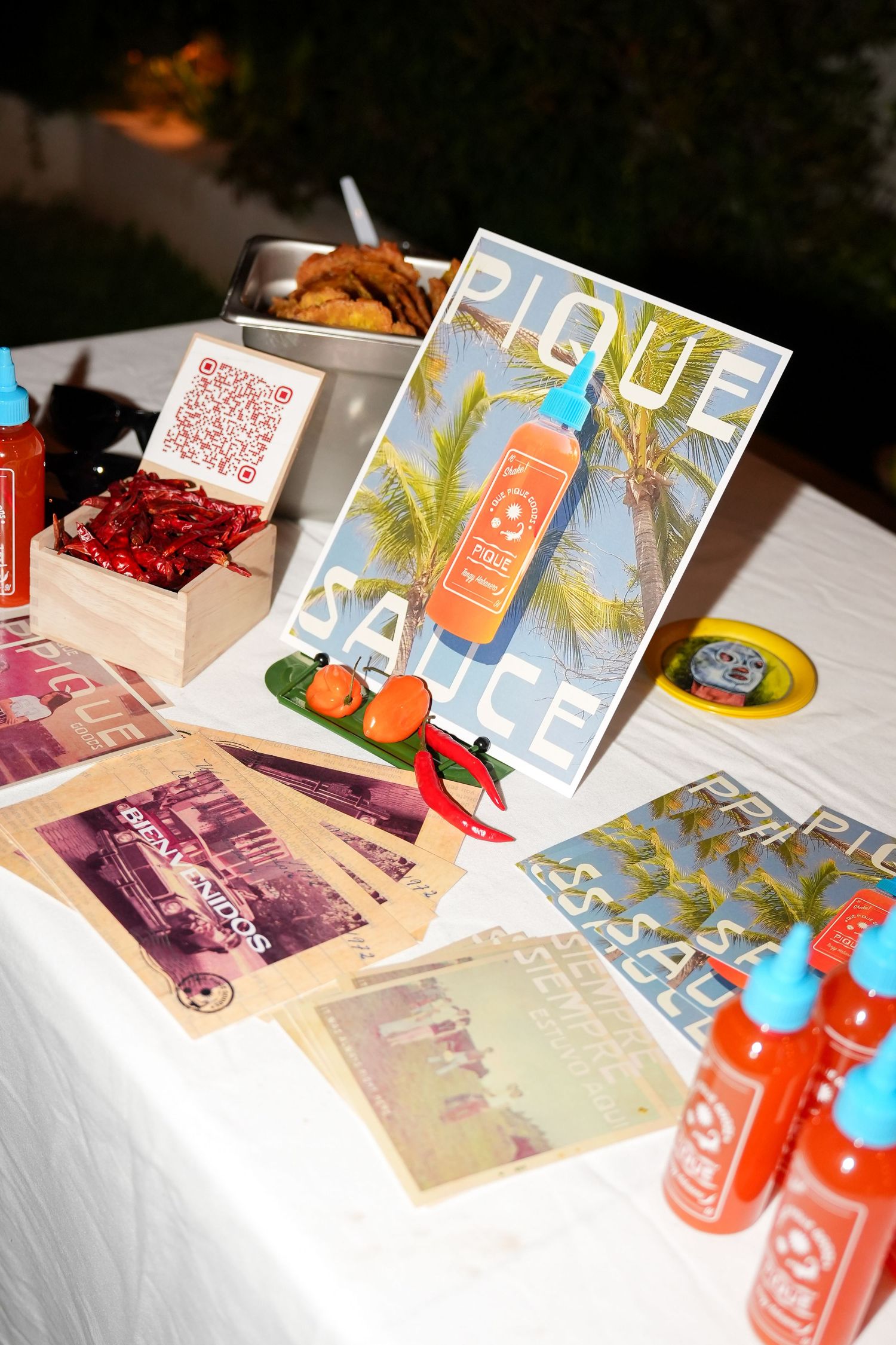 Marketing materials and product displays arranged on a white table with vibrant colors and promotional items.