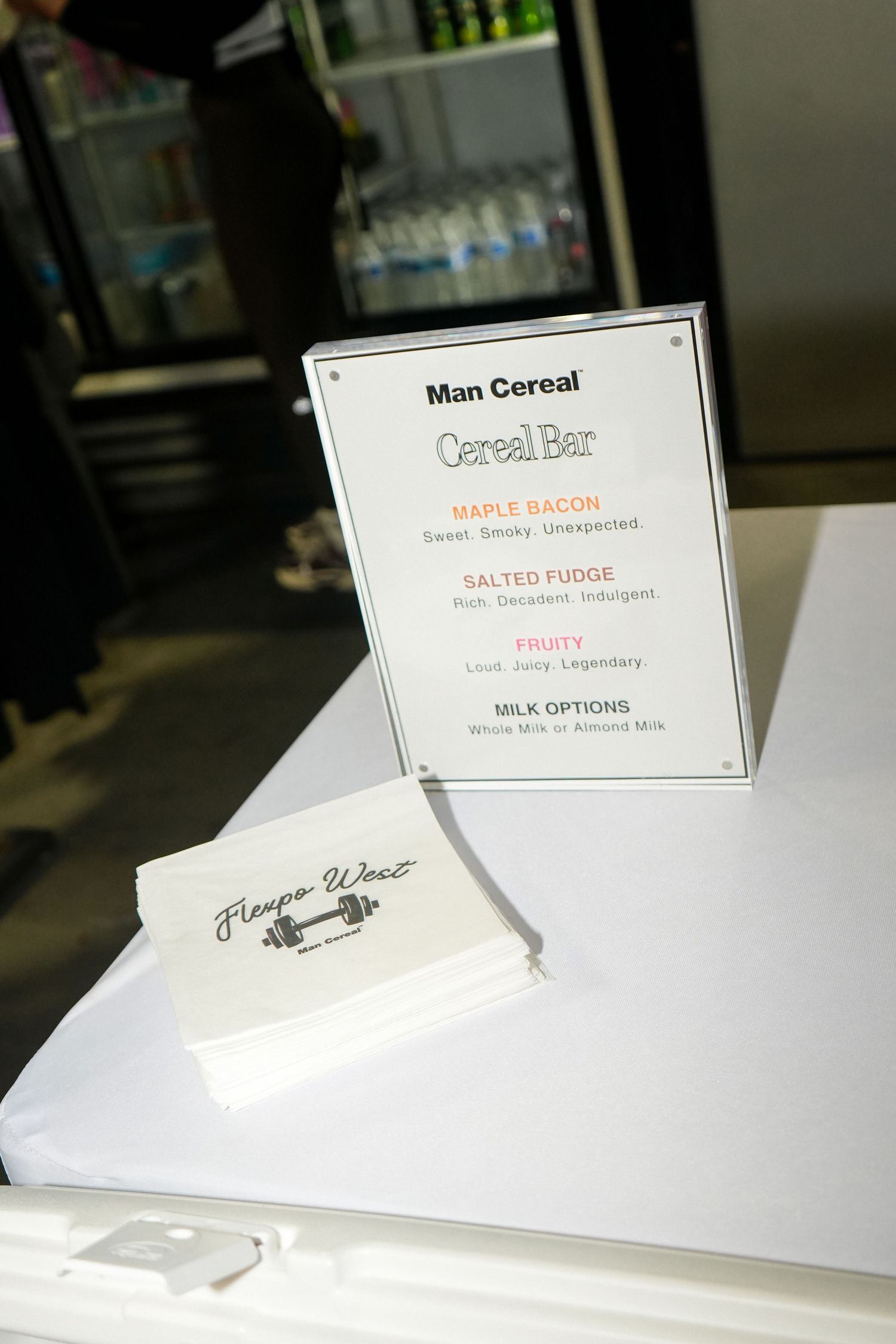 White menu cards displayed on a counter showing cereal and milk options at a restaurant.