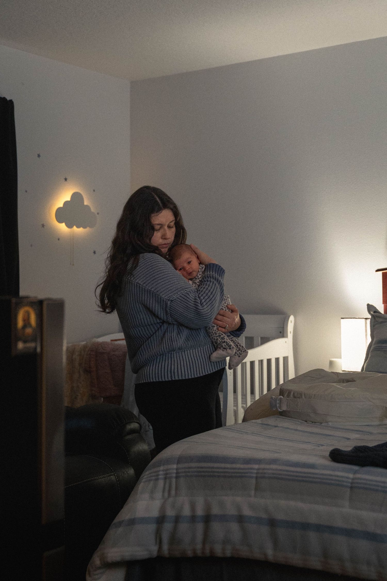 A sequence of photos showing a parent and child sharing tender moments on a bed with striped bedding and soft lighting.