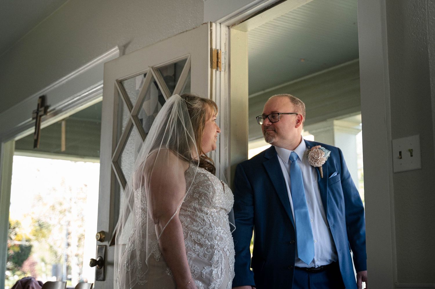 Wedding ceremony preparations in a bright indoor venue with natural lighting.