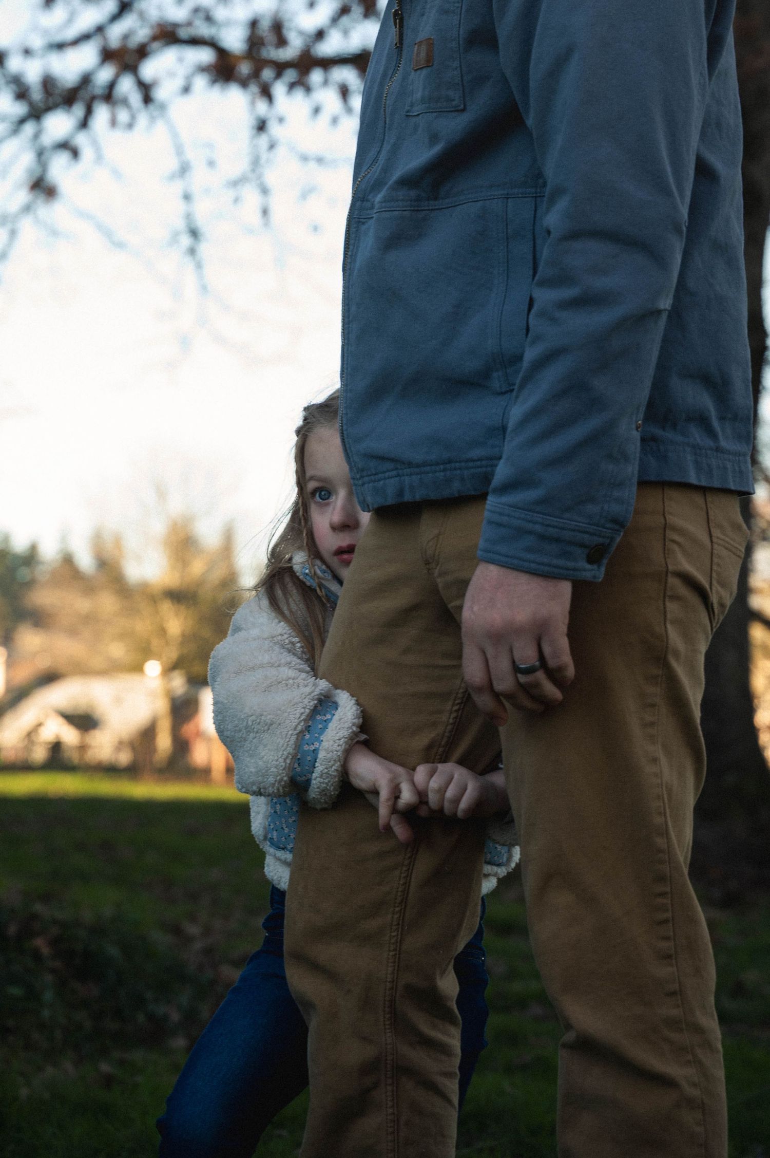A series of cropped photos showing people holding hands outdoors at sunset in casual attire.