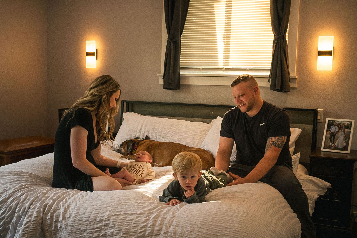 A tender bedtime moment between family members in a warmly lit bedroom.