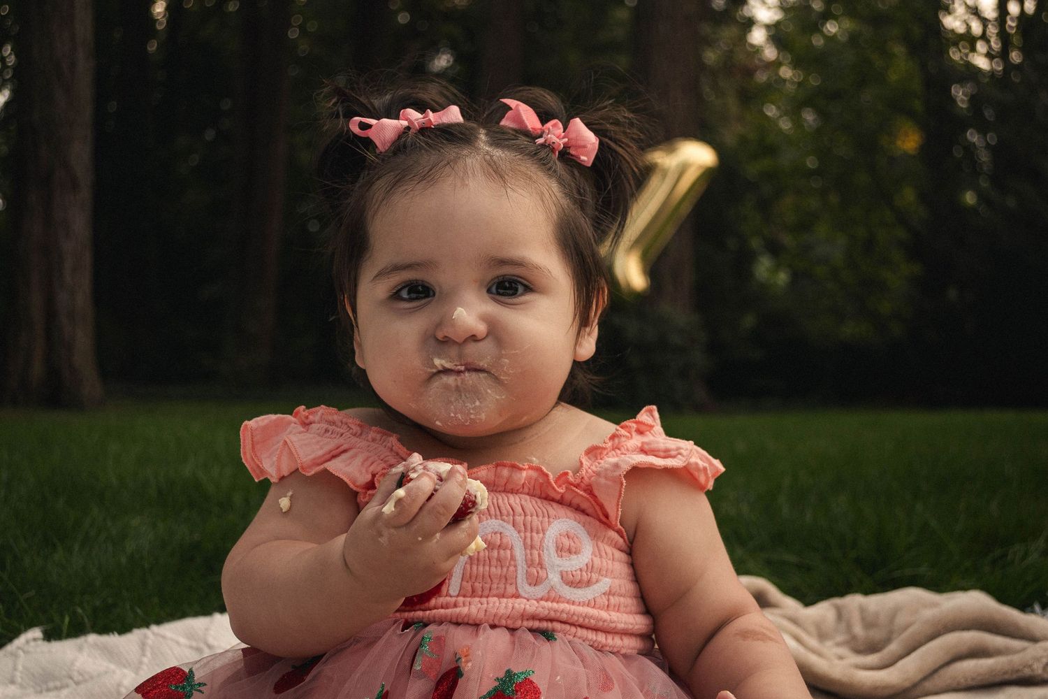 Toddler enjoying cake for their first birthday in Stayton, Oregon.
