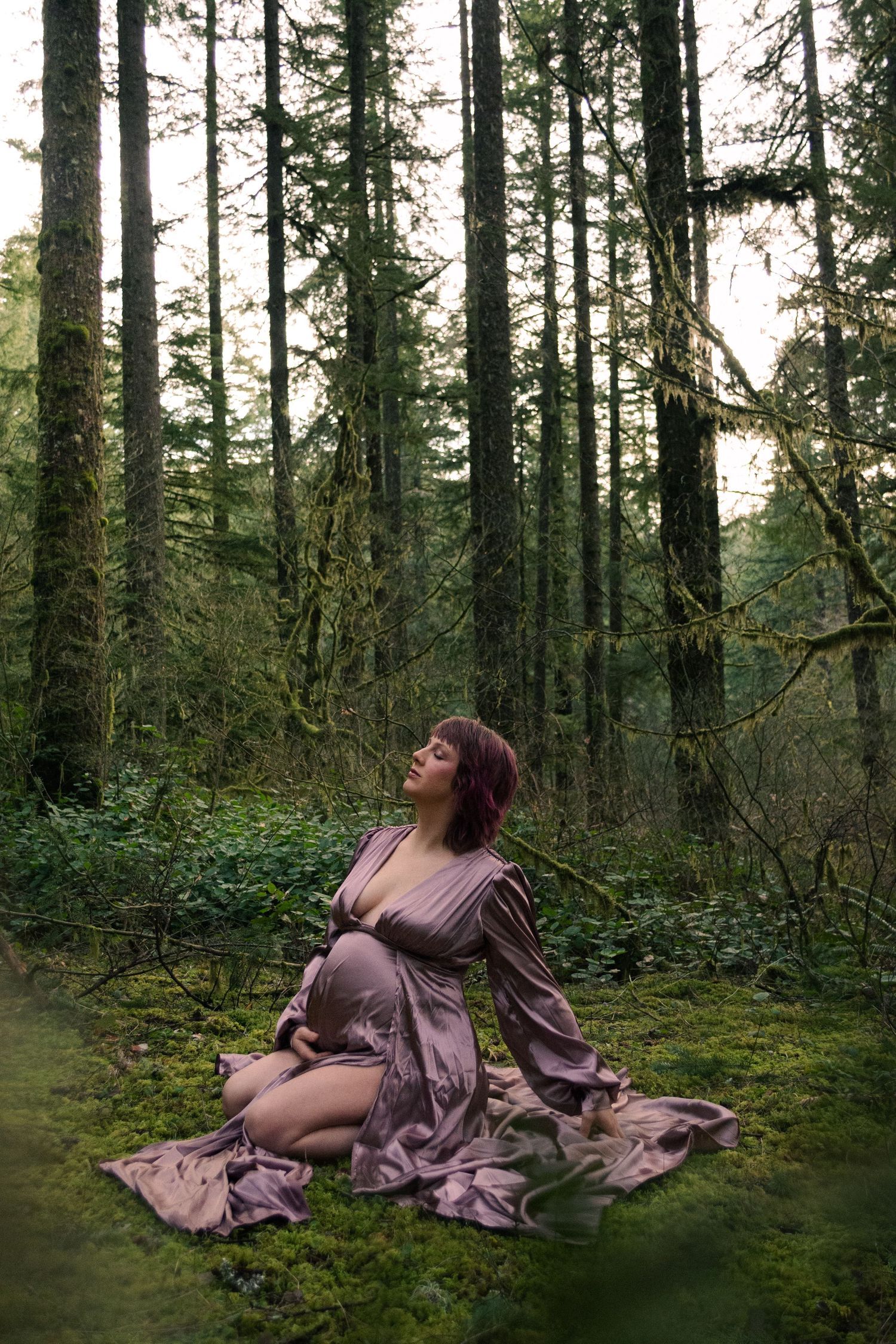 Ethereal forest scene with flowing fabric and moss-covered ground creating a dreamy atmosphere.