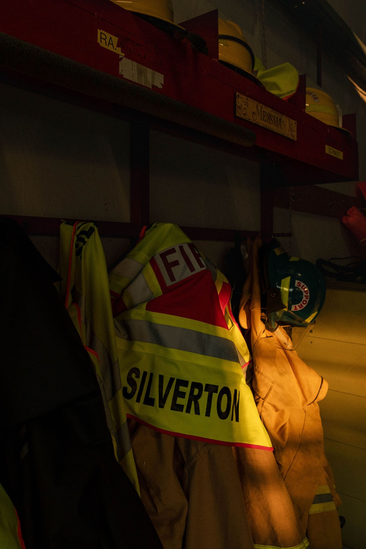 Rescue workers in reflective yellow safety vests working in dark conditions at a mining operation.