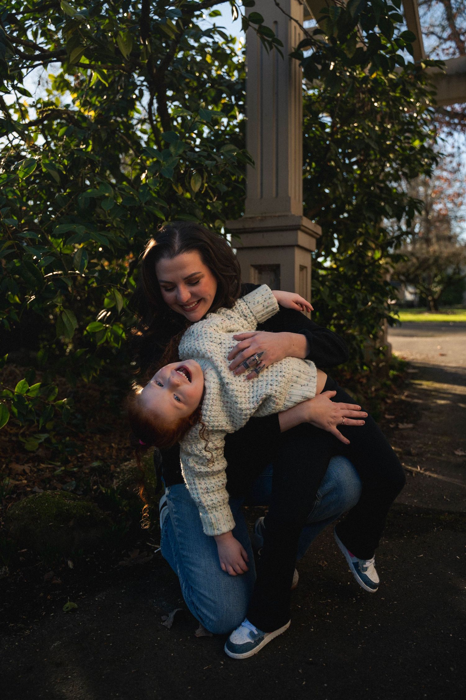 A series of photos showing two people sitting together in a playful moment outdoors among trees and foliage.