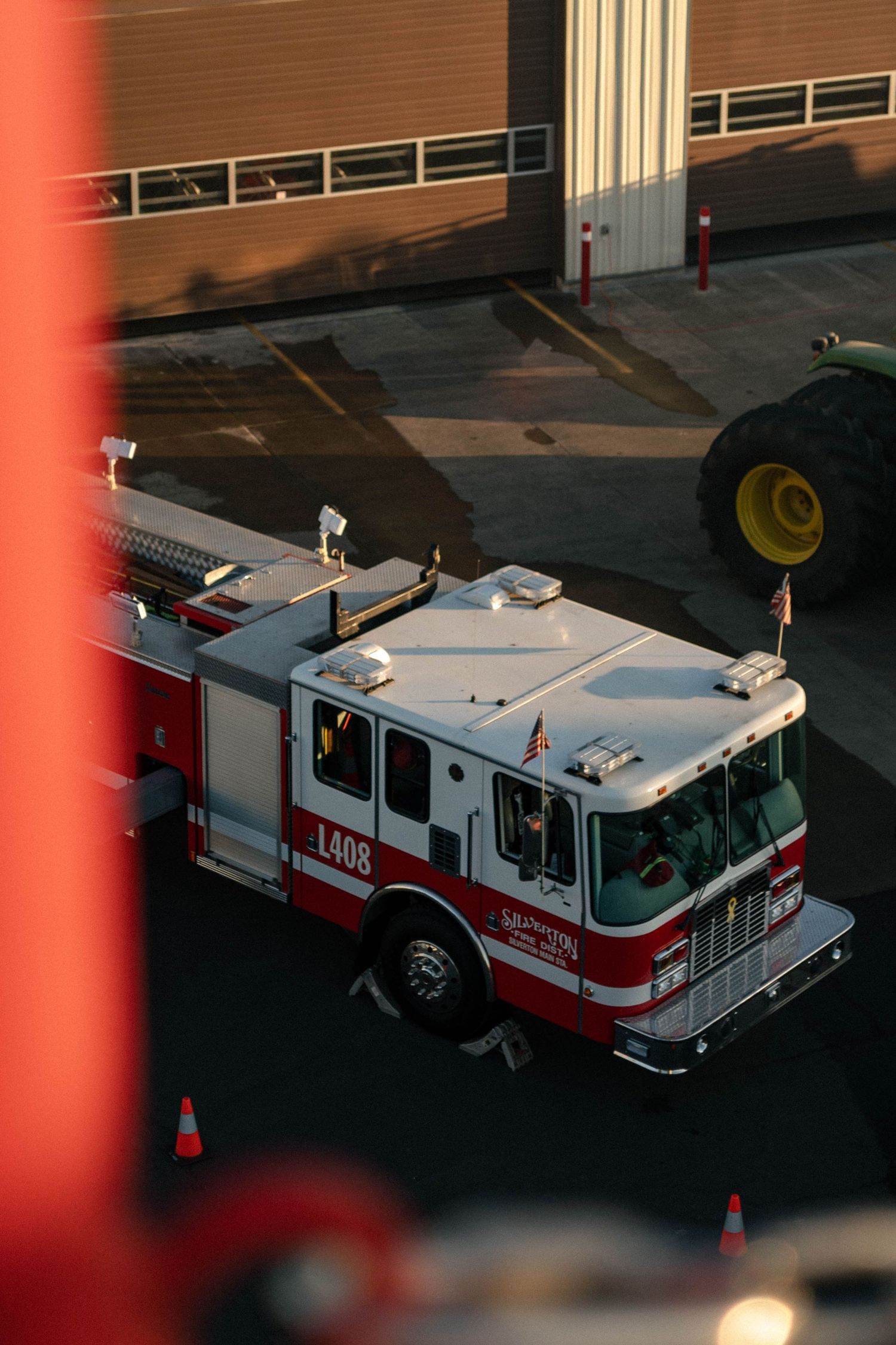 Fire engine truck 008 parked in a lot with traffic cones visible during evening hours.