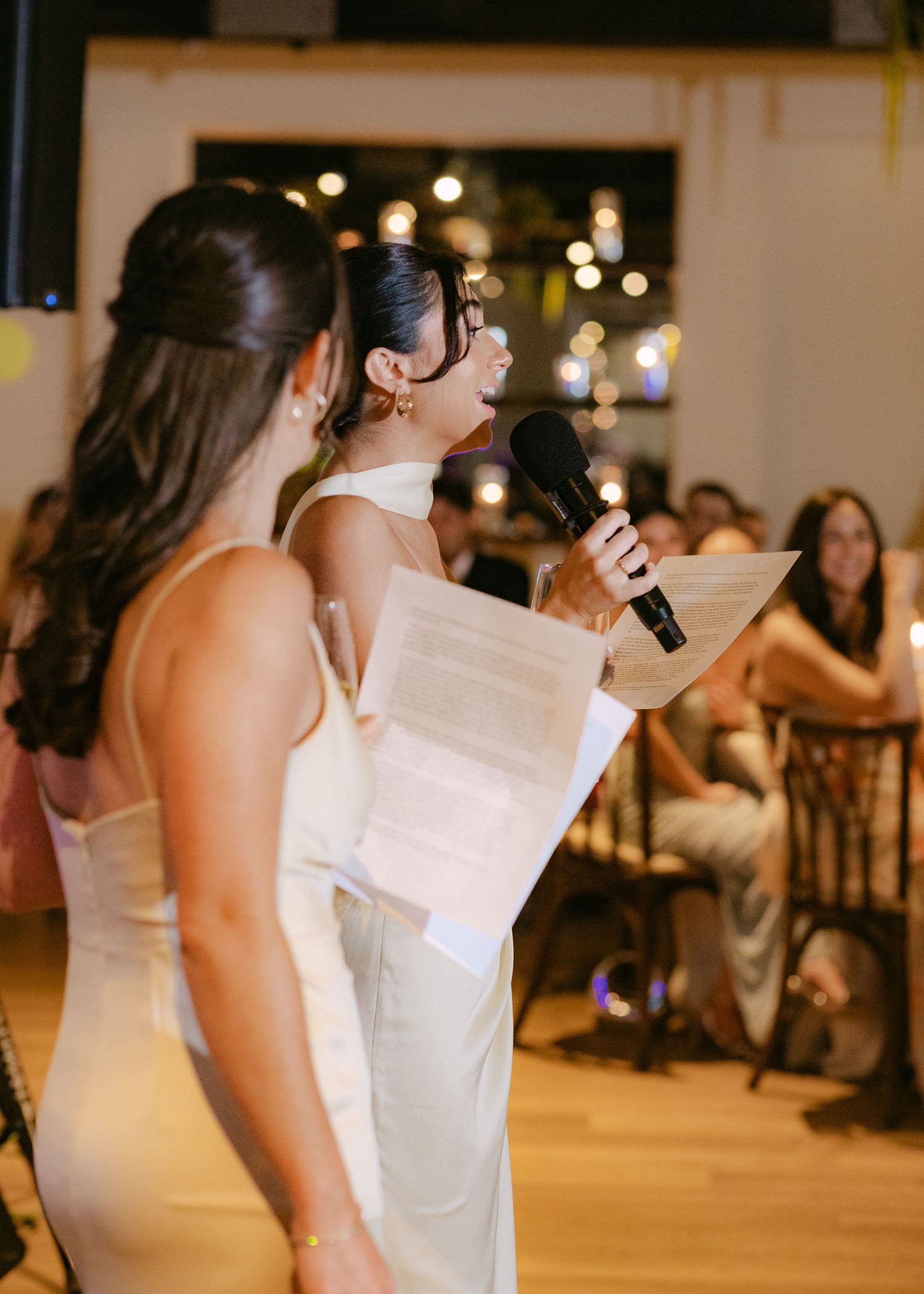 Wedding party members deliver speeches and toasts during a reception celebration.