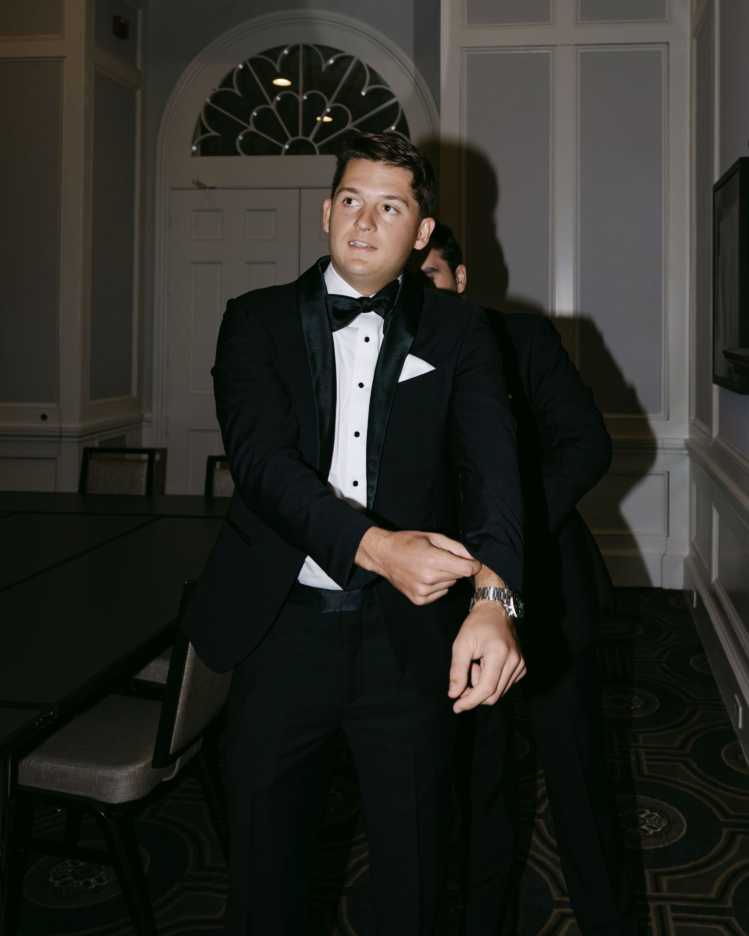 Formal black tuxedo worn at elegant evening event.