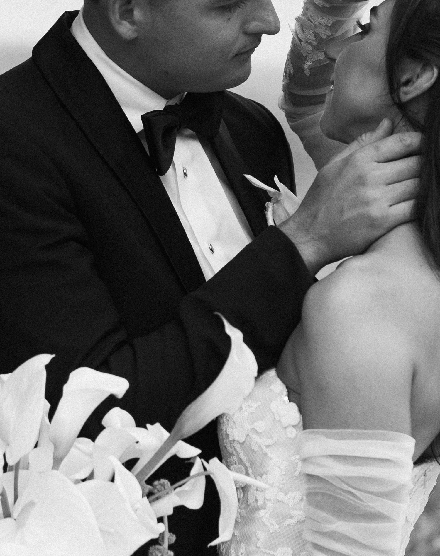 Black and white intimate wedding portrait showing tender moments between the couple.