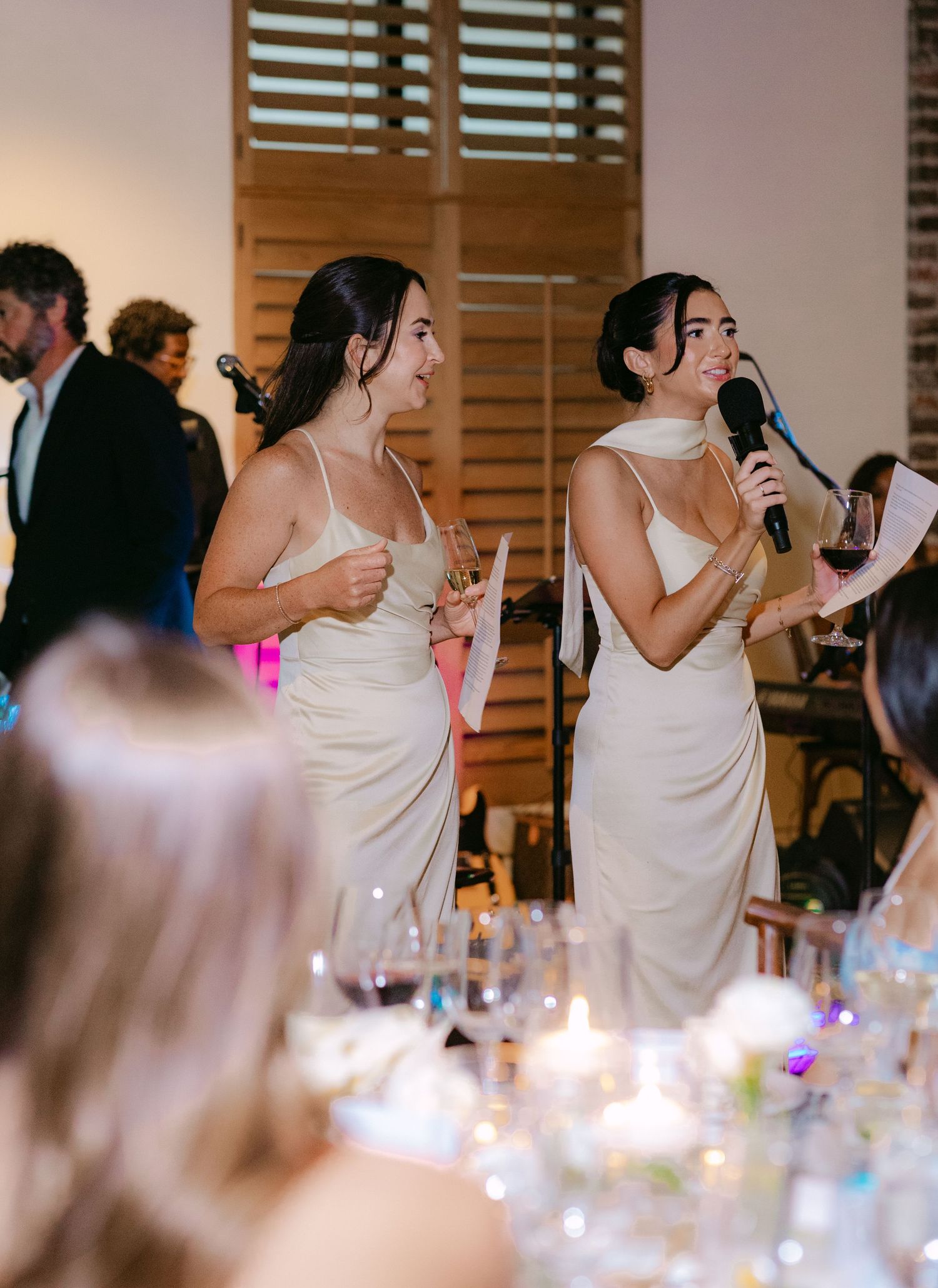 Candlelit wedding reception with guests dancing and celebrating.