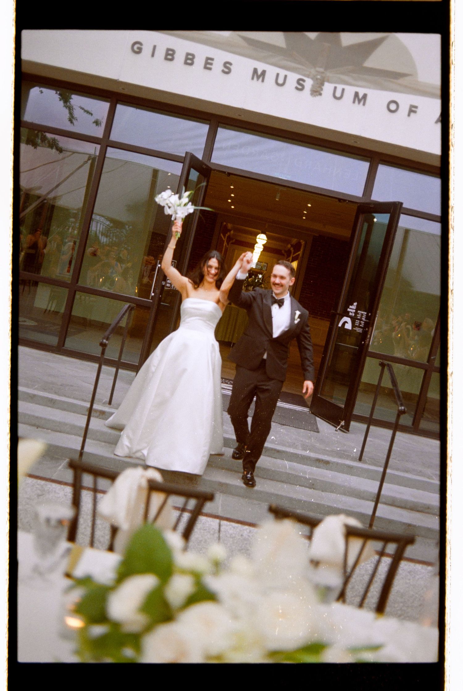 Newlyweds celebrate exiting the Gibbes Museum of Art after their wedding ceremony.